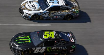 TALLADEGA, ALABAMA - OCTOBER 01: Ty Gibbs, driver of the #54 Monster Energy Toyota, and Kevin Harvick, driver of the #4 Busch Light Camo Ford, race during the NASCAR Cup Series YellaWood 500 at Talladega Superspeedway on October 01, 2023 in Talladega, Alabama. (Photo by Sean Gardner/Getty Images) | Getty Images