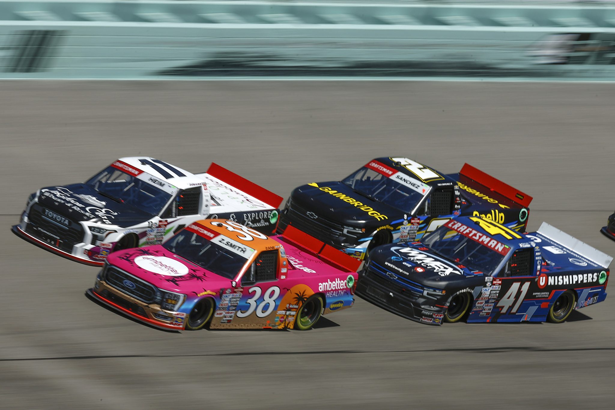 HOMESTEAD, FLORIDA - OCTOBER 21: Zane Smith, driver of the #38 Ambetter Health Ford, Corey Heim, driver of the #11 Chateau Elan/Explore Braselton Toyota, Bayley Currey, driver of the #41 Unishippers Chevrolet, and Nick Sanchez, driver of the #2 Gainbridge Chevrolet, race during the NASCAR Craftsman Truck Series Baptist Health Cancer Care 200 at Homestead-Miami Speedway on October 21, 2023 in Homestead, Florida. (Photo by Sean Gardner/Getty Images) | Getty Images