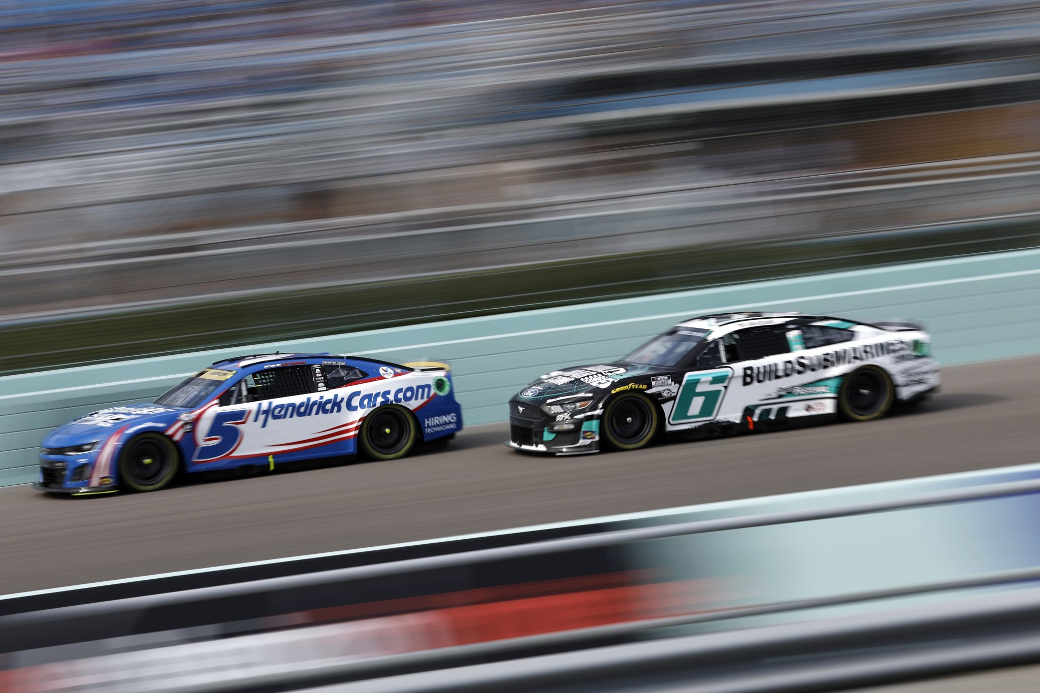 HOMESTEAD, FLORIDA - OCTOBER 22: Kyle Larson, driver of the #5 HendrickCars.com Chevrolet, and Brad Keselowski, driver of the #6 BuildSubmarines.com Ford, race during the NASCAR Cup Series 4EVER 400 Presented by Mobil 1 at Homestead-Miami Speedway on October 22, 2023 in Homestead, Florida. (Photo by James Gilbert/Getty Images) | Getty Images