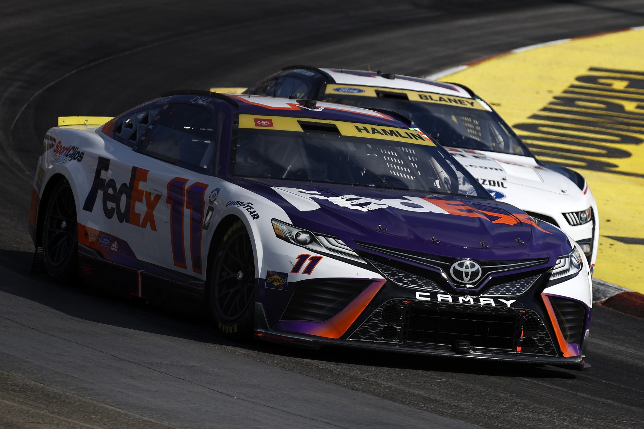 MARTINSVILLE, VIRGINIA - OCTOBER 29: Denny Hamlin, driver of the #11 FedEx Toyota, and Ryan Blaney, driver of the #12 Discount Tire Ford, race during the NASCAR Cup Series Xfinity 500 at Martinsville Speedway on October 29, 2023 in Martinsville, Virginia. (Photo by Chris Graythen/Getty Images) | Getty Images