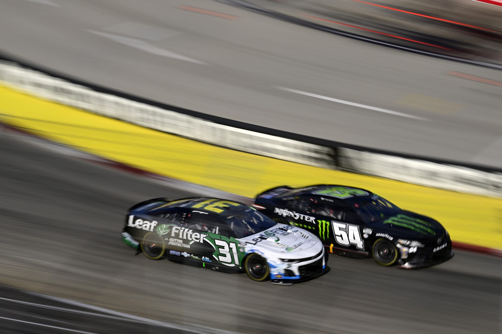 MARTINSVILLE, VIRGINIA - OCTOBER 29: Justin Haley, driver of the #31 LeafFilter Gutter Protection Chevrolet, and Ty Gibbs, driver of the #54 Monster Energy Toyota, race during the NASCAR Cup Series Xfinity 500 at Martinsville Speedway on October 29, 2023 in Martinsville, Virginia. (Photo by Logan Whitton/Getty Images) | Getty Images