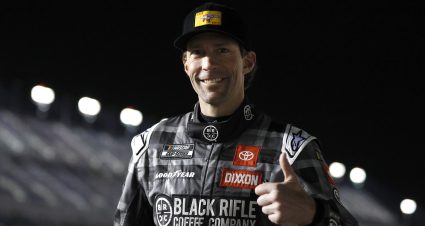 DAYTONA BEACH, FLORIDA - FEBRUARY 15: Travis Pastrana, driver of the #67 Black Rifle Coffee Toyota, gives a thumbs up on the grid during qualifying for the Busch Light Pole at Daytona International Speedway on February 15, 2023 in Daytona Beach, Florida. (Photo by Sean Gardner/Getty Images) | Getty Images