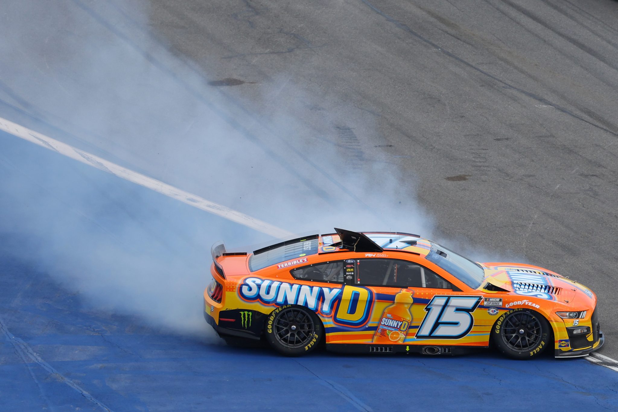DAYTONA BEACH, FLORIDA - FEBRUARY 19: Riley Herbst, driver of the #15 SunnyD Ford, spins after an on-track incident during the NASCAR Cup Series 65th Annual Daytona 500 at Daytona International Speedway on February 19, 2023 in Daytona Beach, Florida. (Photo by Mike Ehrmann/Getty Images) | Getty Images