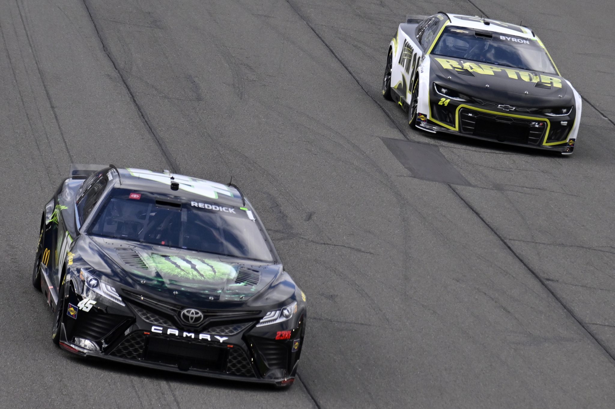 FONTANA, CALIFORNIA - FEBRUARY 26: Tyler Reddick, driver of the #45 The Beast Unleashed Toyota, and William Byron, driver of the #24 RaptorTough.com Chevrolet, race during the NASCAR Cup Series Pala Casino 400 at Auto Club Speedway on February 26, 2023 in Fontana, California. (Photo by Logan Riely/Getty Images) | Getty Images