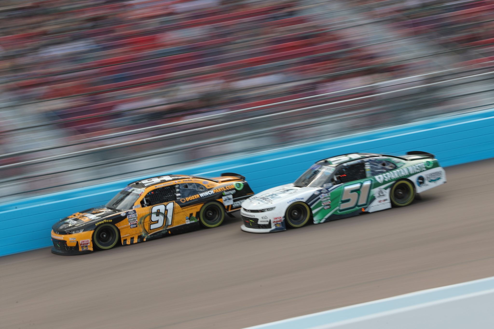 AVONDALE, ARIZONA - MARCH 11: Garrett Smithley, driver of the #91 DozerWinchParts.com Chevrolet, and Jeremy Clements, driver of the #51 Fox Sports/Spartan Waste Chevrolet, race during the NASCAR Xfinity Series United Rentals 200 at Phoenix Raceway on March 11, 2023 in Avondale, Arizona. (Photo by Meg Oliphant/Getty Images) | Getty Images