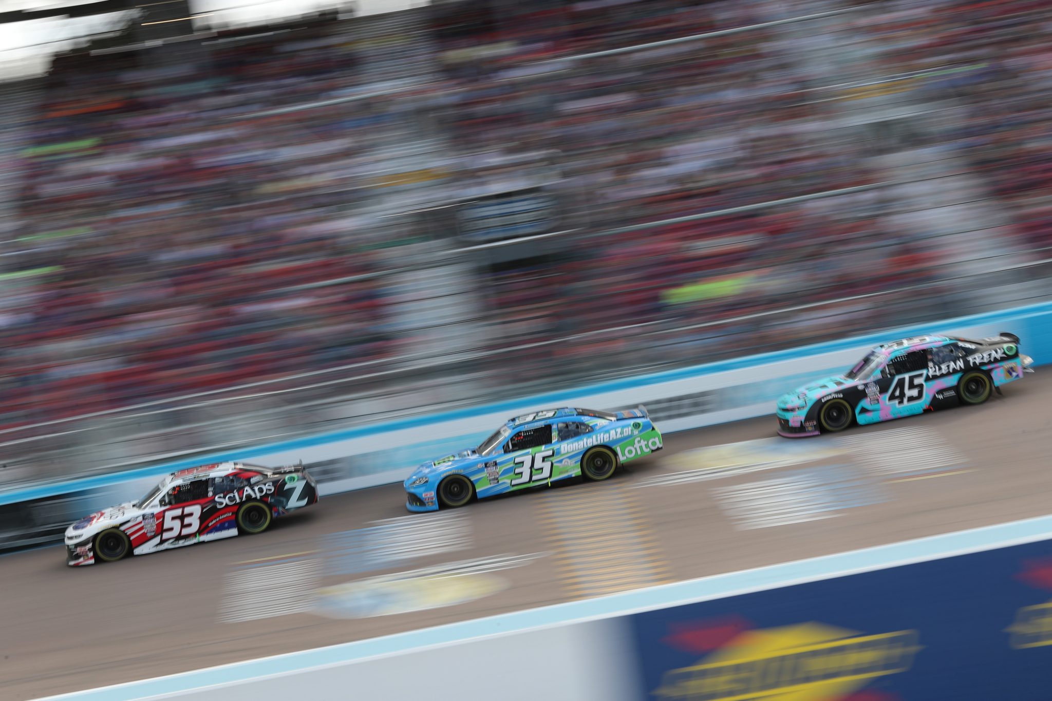 AVONDALE, ARIZONA - MARCH 11: Patrick Emerling, driver of the #53 Sci Aps Chevrolet, Joey Gase, driver of the #35 Nevada Donor Network Toyota, and Leland Honeyman, driver of the #45 Klean Freak Body Wipes Chevrolet, race during the NASCAR Xfinity Series United Rentals 200 at Phoenix Raceway on March 11, 2023 in Avondale, Arizona. (Photo by Meg Oliphant/Getty Images) | Getty Images