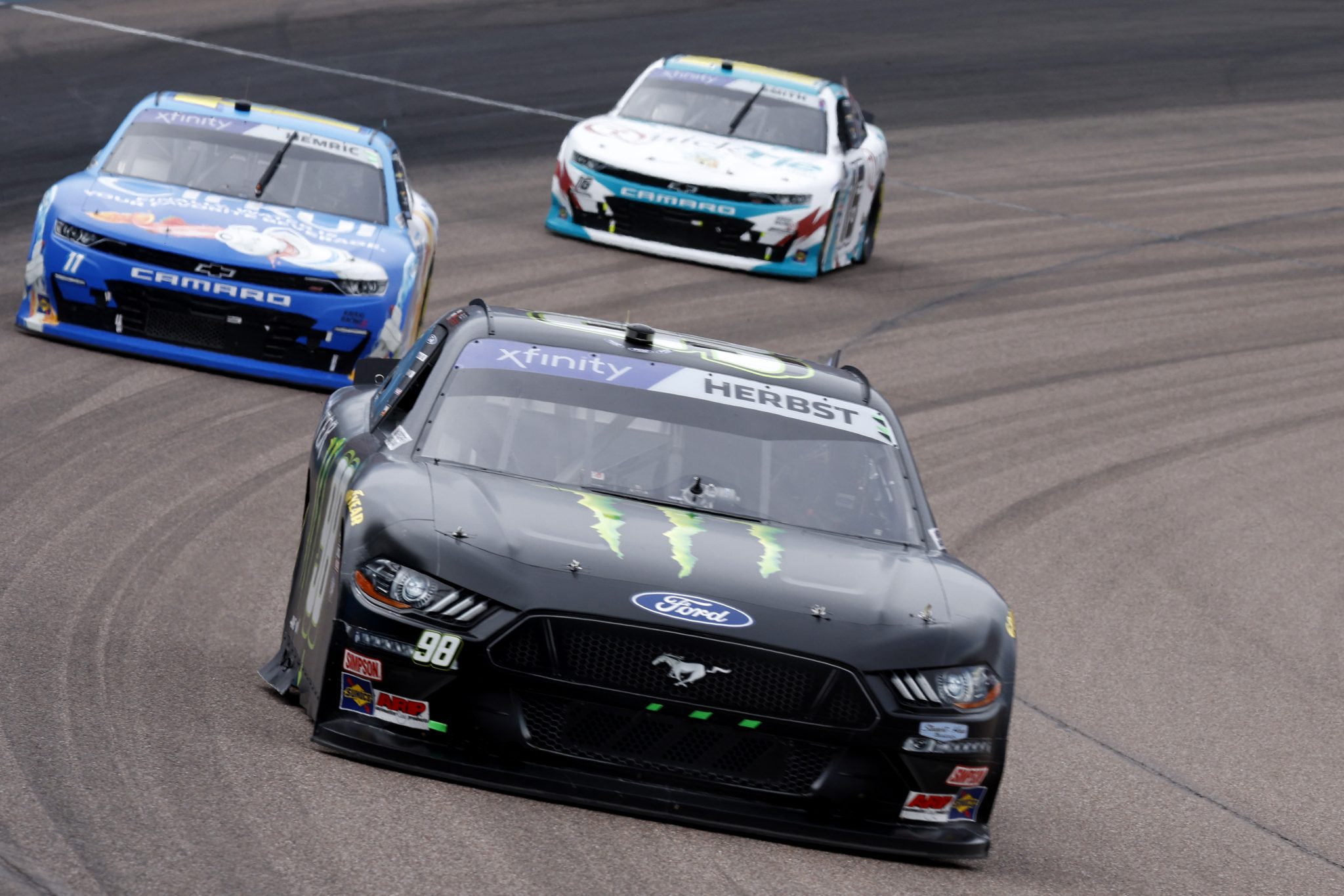 AVONDALE, ARIZONA - MARCH 11: Riley Herbst, driver of the #98 Monster Energy Ford, Daniel Hemric, driver of the #11 Cirkul Chevrolet, and Chandler Smith, driver of the #16 Quick Tie Products Inc. Chevrolet, race during the NASCAR Xfinity Series United Rentals 200 at Phoenix Raceway on March 11, 2023 in Avondale, Arizona. (Photo by Chris Graythen/Getty Images) | Getty Images