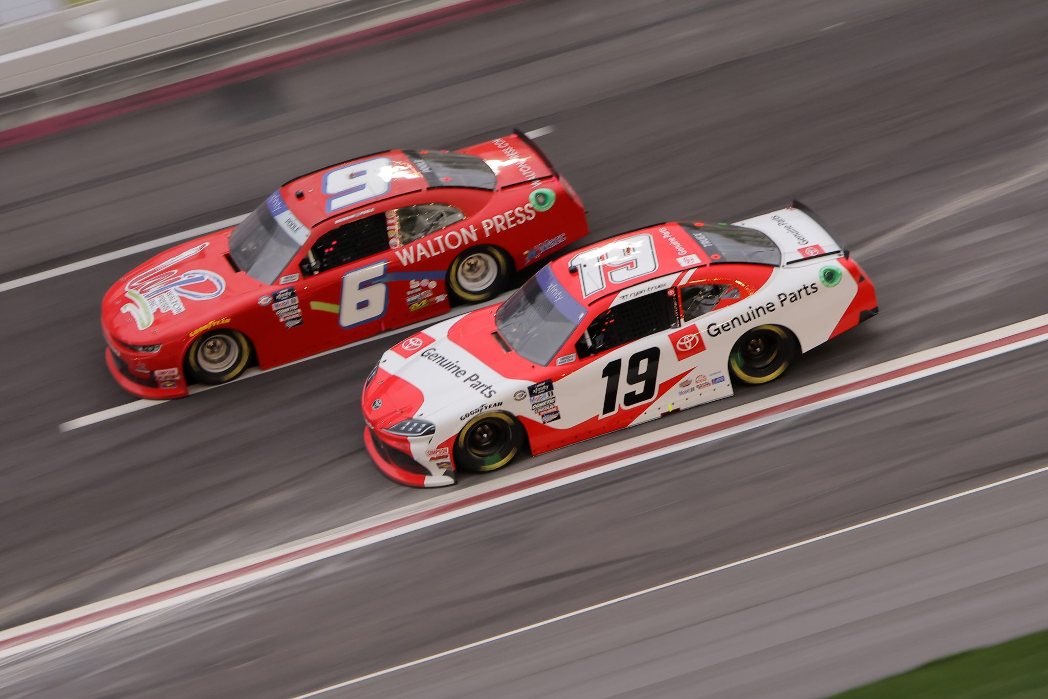 HAMPTON, GEORGIA - MARCH 18: Ryan Truex, driver of the #19 Toyota Genuine Parts Toyota, and Brennan Poole, driver of the #6 Walton Press Inc. Chevrolet, race during the NASCAR Xfinity Series RAPTOR 250 at Atlanta Motor Speedway on March 18, 2023 in Hampton, Georgia. (Photo by Jonathan Bachman/Getty Images) | Getty Images