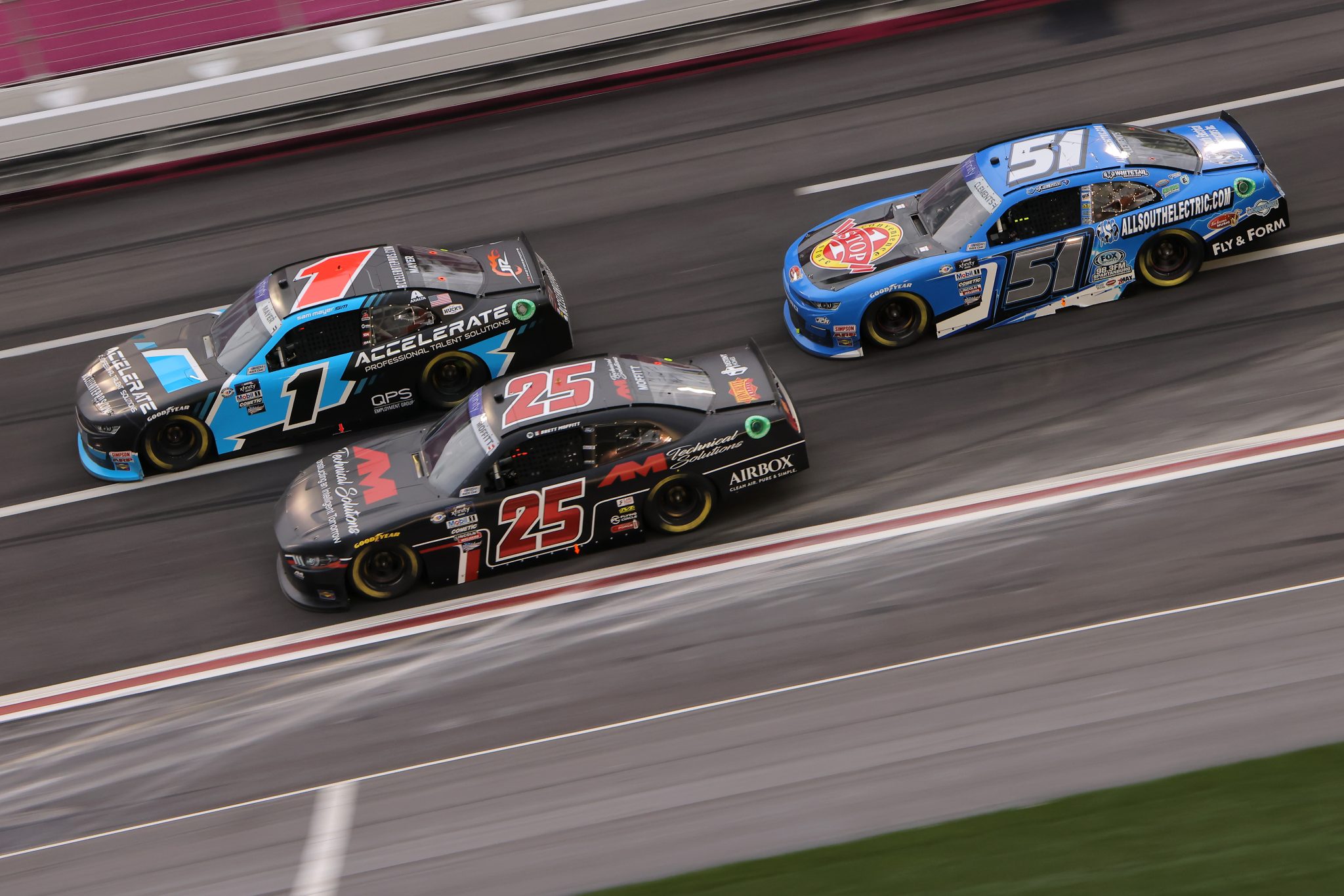 HAMPTON, GEORGIA - MARCH 18: Brett Moffitt, driver of the #25 AM Technical Solutions Ford, Sam Mayer, driver of the #1 Accelerate Pros Talent Chevrolet, and Jeremy Clements, driver of the #51 One Stop/All South Electric Chevrolet, race during the NASCAR Xfinity Series RAPTOR 250 at Atlanta Motor Speedway on March 18, 2023 in Hampton, Georgia. (Photo by Jonathan Bachman/Getty Images) | Getty Images