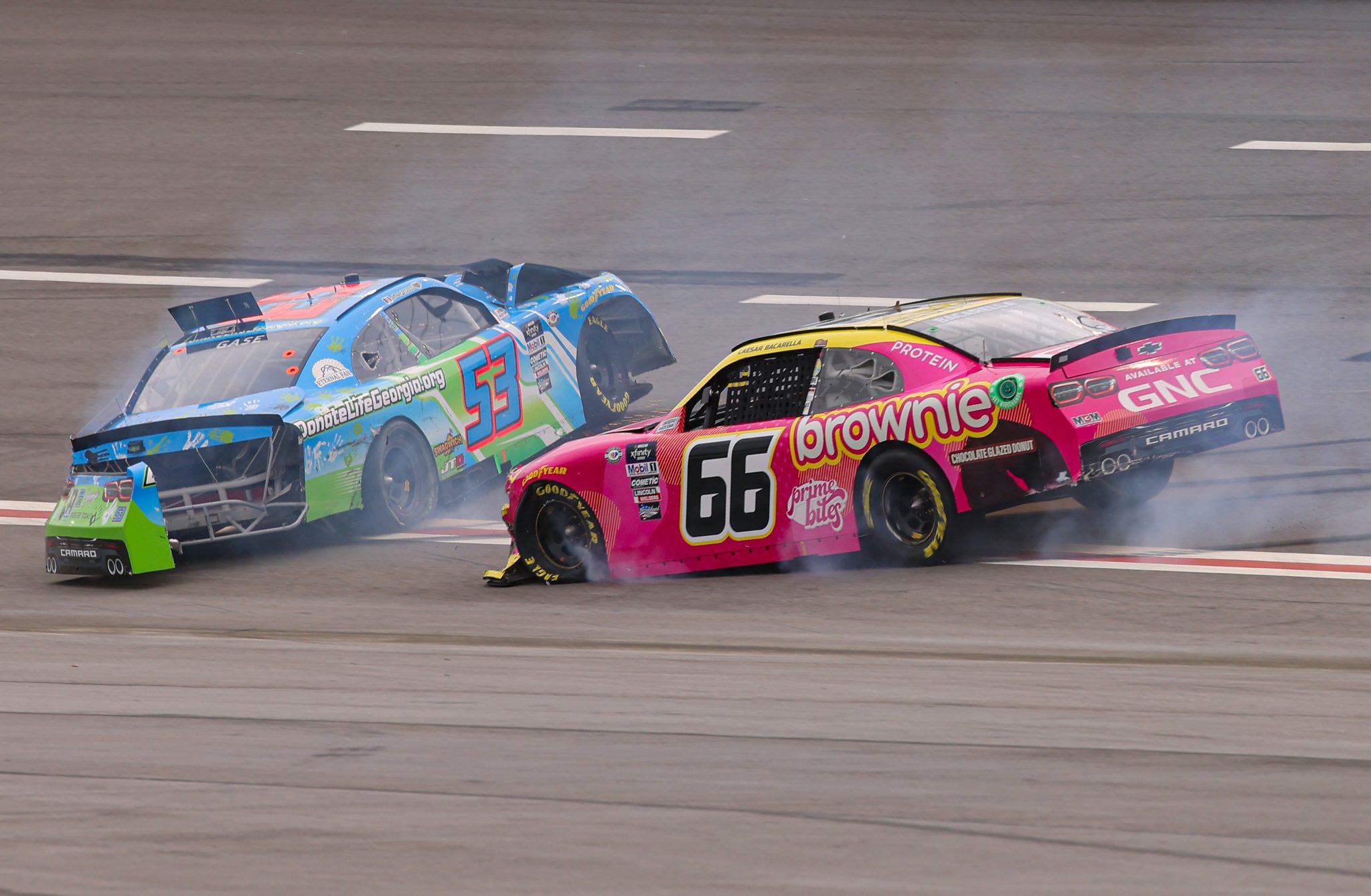 HAMPTON, GEORGIA - MARCH 18: Joey Gase, driver of the #53 Donate Life GA Chevrolet, and Caesar Bacarella, driver of the #66 Prime Bites Protein Brownie Chevrolet, spin after an on-track incident during the NASCAR Xfinity Series RAPTOR 250 at Atlanta Motor Speedway on March 18, 2023 in Hampton, Georgia. (Photo by Jonathan Bachman/Getty Images) | Getty Images