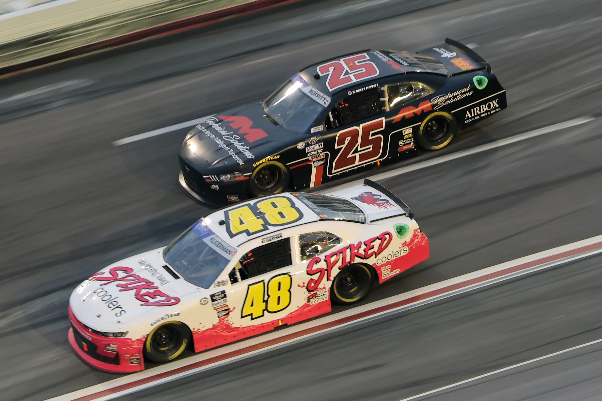 HAMPTON, GEORGIA - MARCH 18: Parker Kligerman, driver of the #48 Big Machine Racing Spiked Chevrolet, and Brett Moffitt, driver of the #25 AM Technical Solutions Ford, race during the NASCAR Xfinity Series RAPTOR 250 at Atlanta Motor Speedway on March 18, 2023 in Hampton, Georgia. (Photo by Jonathan Bachman/Getty Images) | Getty Images
