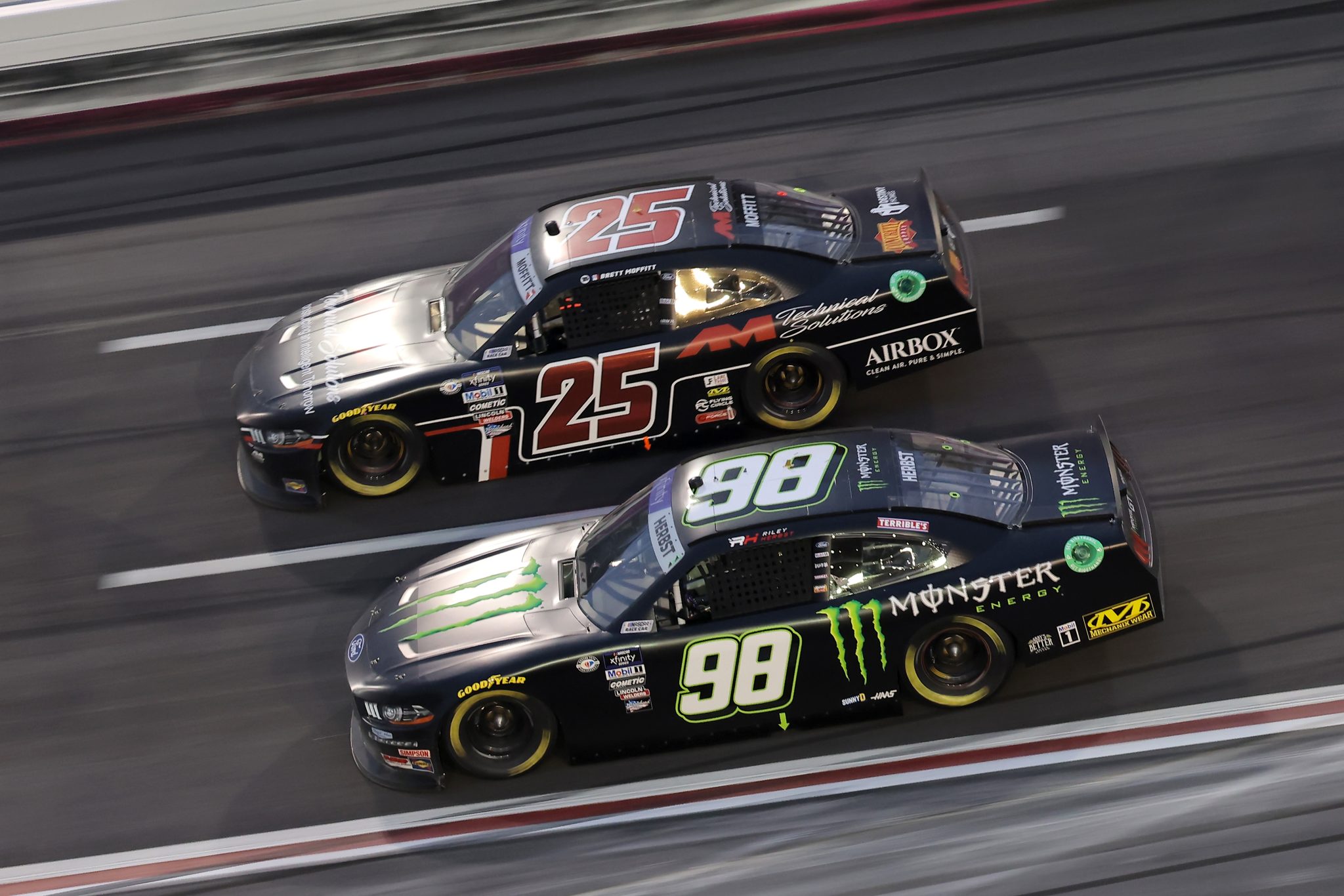 HAMPTON, GEORGIA - MARCH 18: Riley Herbst, driver of the #98 Monster Energy Ford, and Brett Moffitt, driver of the #25 AM Technical Solutions Ford, race during the NASCAR Xfinity Series RAPTOR 250 at Atlanta Motor Speedway on March 18, 2023 in Hampton, Georgia. (Photo by Jonathan Bachman/Getty Images) | Getty Images