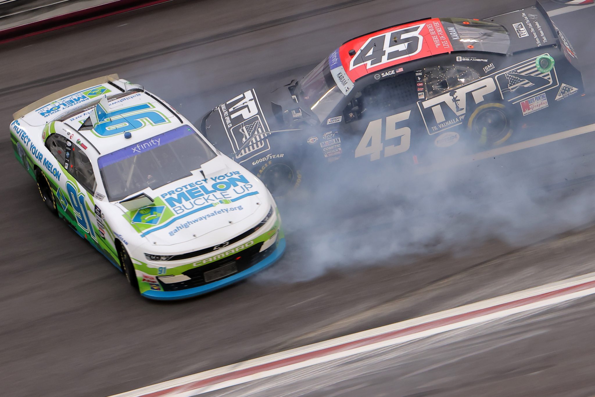 HAMPTON, GEORGIA - MARCH 18: Chad Chastain, driver of the #91 Protect Your Melon Chevrolet, and Sage Karam, driver of the #45 Til Valhalla Project Chevrolet, spin after an on-track incident during the NASCAR Xfinity Series RAPTOR 250 at Atlanta Motor Speedway on March 18, 2023 in Hampton, Georgia. (Photo by Jonathan Bachman/Getty Images) | Getty Images