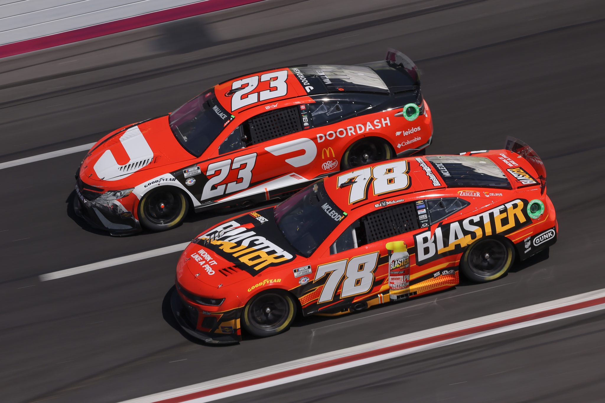 HAMPTON, GEORGIA - MARCH 19: BJ McLeod, driver of the #78 B'laster Chevrolet, and Bubba Wallace, driver of the #23 DoorDash Toyota, race during the NASCAR Cup Series Ambetter Health 400 at Atlanta Motor Speedway on March 19, 2023 in Hampton, Georgia. (Photo by Jonathan Bachman/Getty Images) | Getty Images