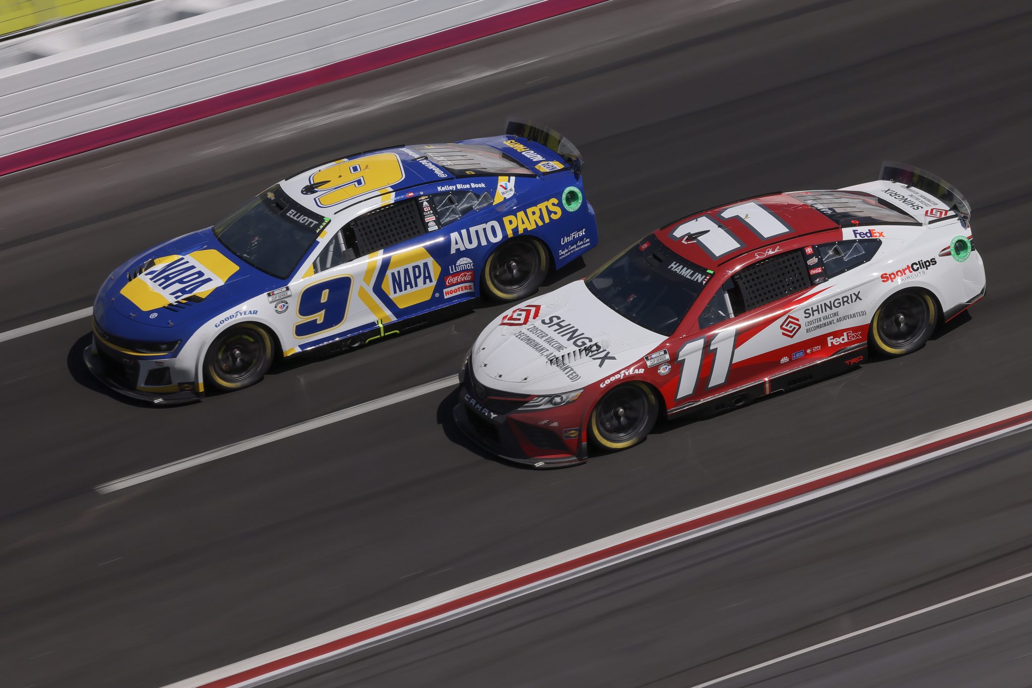 HAMPTON, GEORGIA - MARCH 19: Josh Berry, driver of the #9 NAPA Auto Parts Chevrolet, and Denny Hamlin, driver of the #11 Shingrix Toyota, race during the NASCAR Cup Series Ambetter Health 400 at Atlanta Motor Speedway on March 19, 2023 in Hampton, Georgia. (Photo by Jonathan Bachman/Getty Images) | Getty Images