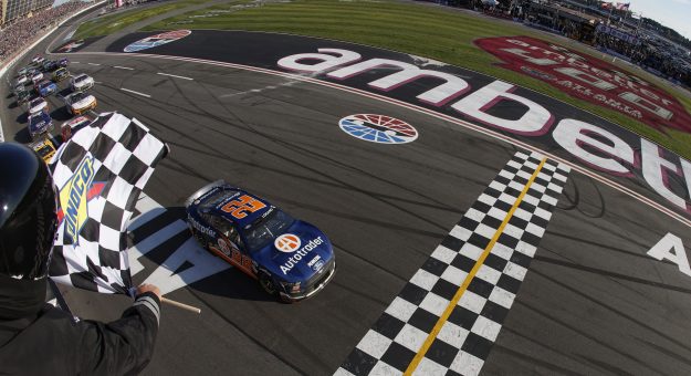 HAMPTON, GEORGIA - MARCH 19: Joey Logano, driver of the #22 Autotrader Ford, takes the checkered flag to win the NASCAR Cup Series Ambetter Health 400 at Atlanta Motor Speedway on March 19, 2023 in Hampton, Georgia. (Photo by Sean Gardner/Getty Images) | Getty Images