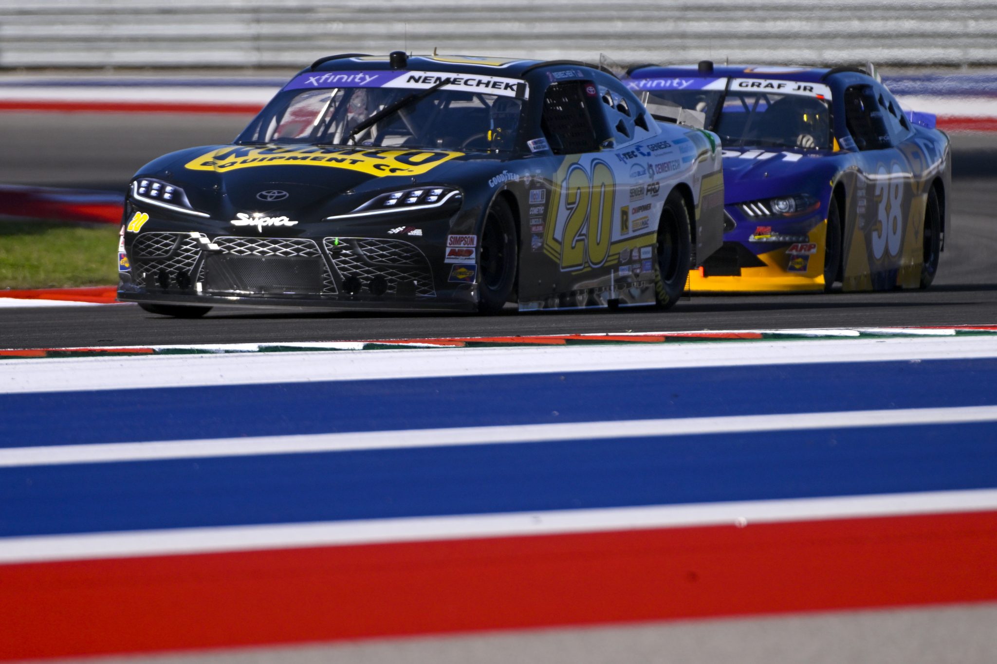 AUSTIN, TEXAS - MARCH 24: John Hunter Nemechek, driver of the #20 Romco Equipment Toyota, drives with flames ahead of Joe Graf Jr., driver of the #38 G-Coin Ford, during practice for the NASCAR Xfinity Series Pit Boss 250 at Circuit of The Americas on March 24, 2023 in Austin, Texas. (Photo by Logan Riely/Getty Images) | Getty Images