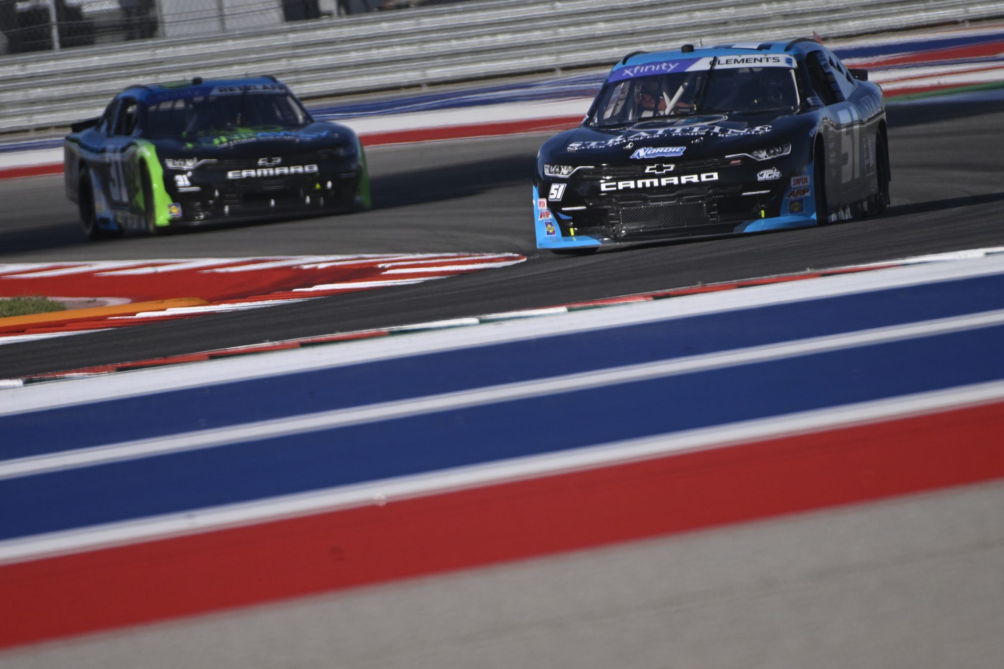 AUSTIN, TEXAS - MARCH 24: Jeremy Clements, driver of the #51 Straitline Nitro Chevrolet, and Parker Retzlaff, driver of the #31 FUNKAWAY Chevrolet, drive during practice for the NASCAR Xfinity Series Pit Boss 250 at Circuit of The Americas on March 24, 2023 in Austin, Texas. (Photo by Logan Riely/Getty Images) | Getty Images