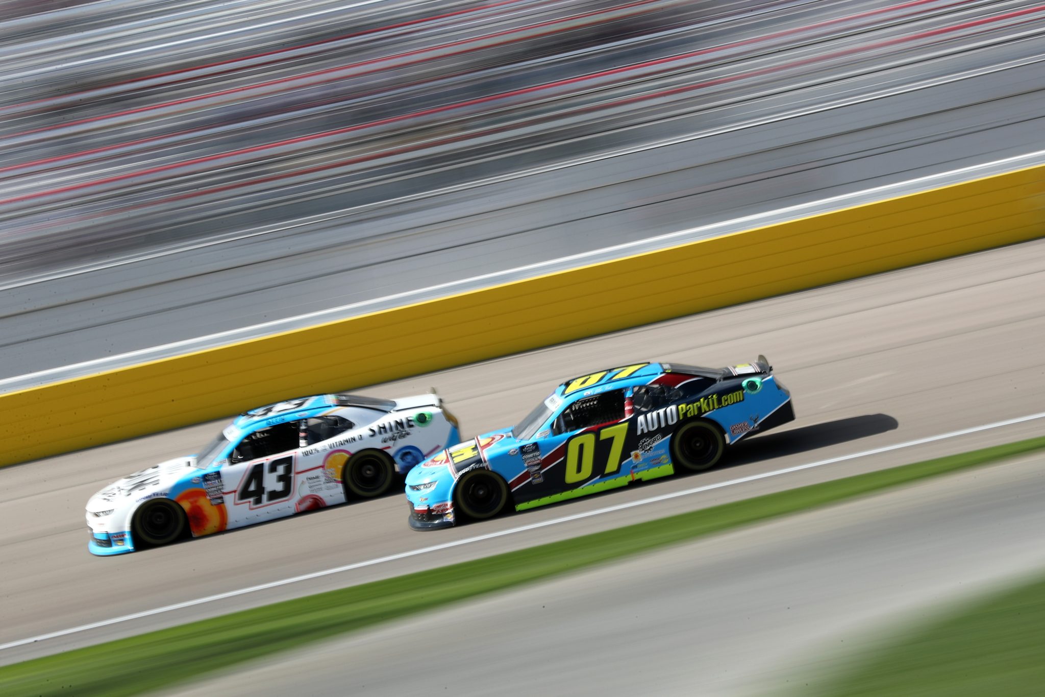 LAS VEGAS, NEVADA - MARCH 04: Ryan Ellis, driver of the #43 Shine Water Chevrolet, and Blaine Perkins, driver of the #07 AUTOPARKit.com Chevrolet, race during the NASCAR Xfinity Series Alsco Uniforms 300 at Las Vegas Motor Speedway on March 04, 2023 in Las Vegas, Nevada. (Photo by Meg Oliphant/Getty Images) | Getty Images