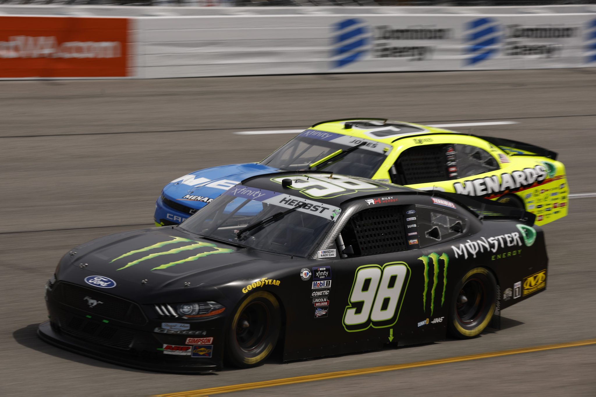 RICHMOND, VIRGINIA - APRIL 01: Riley Herbst, driver of the #98 Monster Energy Ford, and Brandon Jones, driver of the #9 Menards/NIBCO Chevrolet, race during the NASCAR Xfinity Series ToyotaCare 250 at Richmond Raceway on April 01, 2023 in Richmond, Virginia. (Photo by Jared C. Tilton/Getty Images) | Getty Images