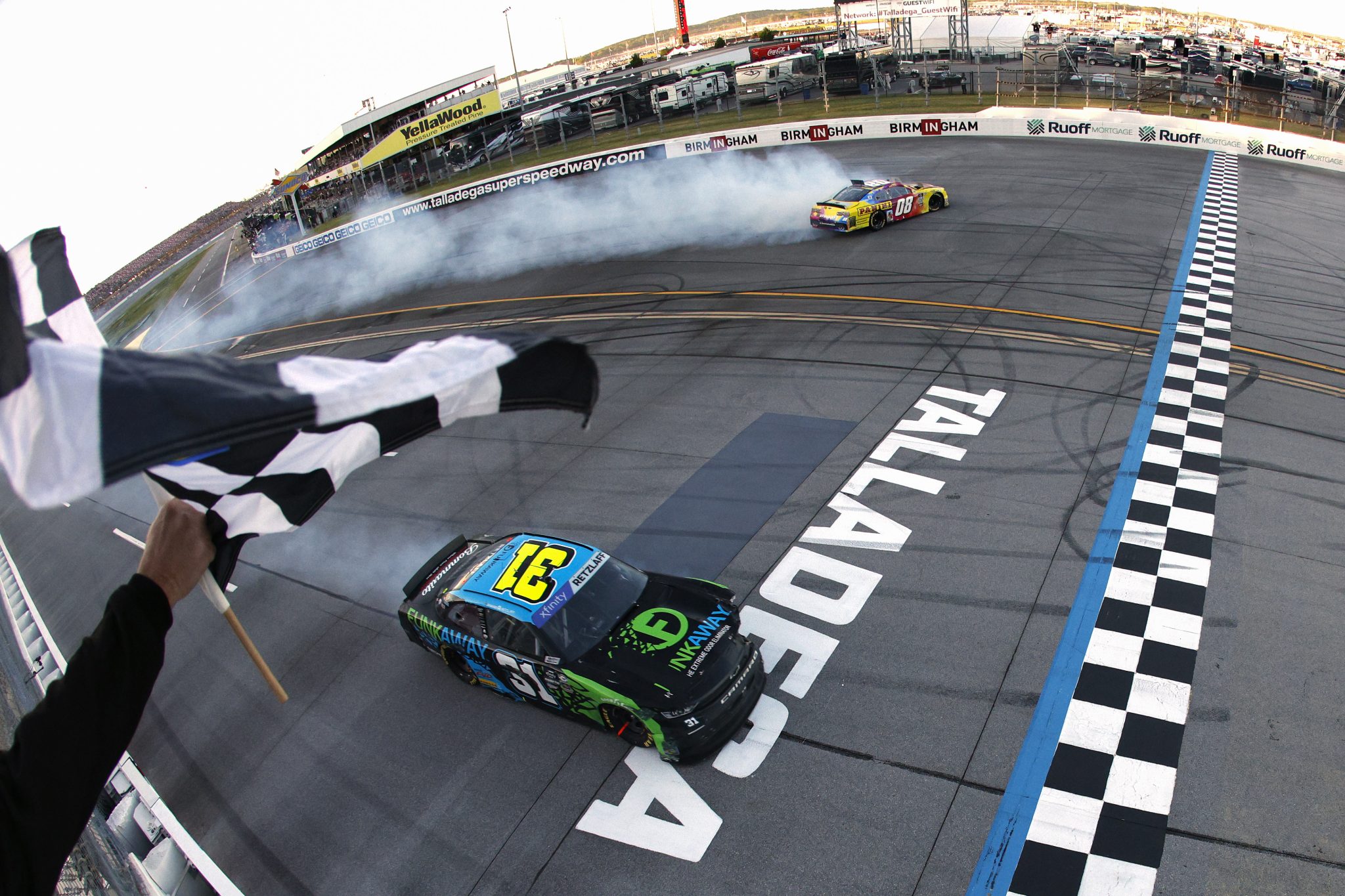 TALLADEGA, ALABAMA - APRIL 22: Gray Gaulding, driver of the #08 Panini NFT Chevrolet, and Parker Retzlaff, driver of the #31 FUNKAWAY Chevrolet, spin across the finish line after an on-track incident to end the NASCAR Xfinity Series Ag-Pro 300 at Talladega Superspeedway on April 22, 2023 in Talladega, Alabama. (Photo by Sean Gardner/Getty Images) | Getty Images