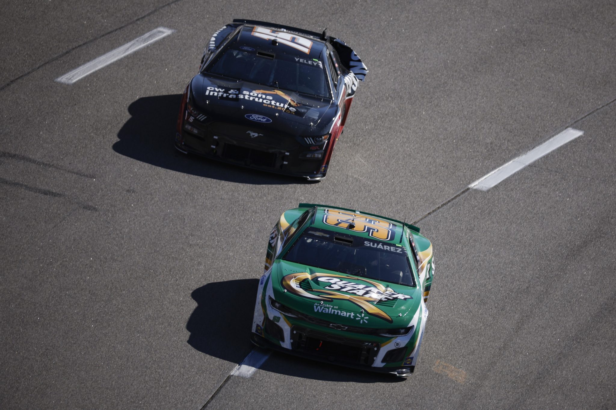 RICHMOND, VIRGINIA - APRIL 02: Daniel Suarez, driver of the #99 Quaker State Chevrolet, and JJ Yeley, driver of the #15 CW & Sons Infrastructure Ford, race during the NASCAR Cup Series Toyota Owners 400 at Richmond Raceway on April 02, 2023 in Richmond, Virginia. (Photo by Jared C. Tilton/Getty Images) | Getty Images