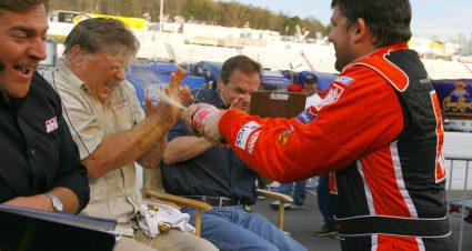 MARTINSVILLE, VA - APRIL 02:  Tony Stewart, driver of the #20 Home Depot Chevrolet, sprays (L-R) TV personality John Roberts, driver Jimmy Spencer and driver Kenny Wallace after winning the NASCAR Nextel Cup Series DirectTV 500 on April 2, 2006 at the Martinsville Speedway in Martinsville, Virginia.  (Photo by Rusty Jarrett/Getty Images for NASCAR) | Getty Images