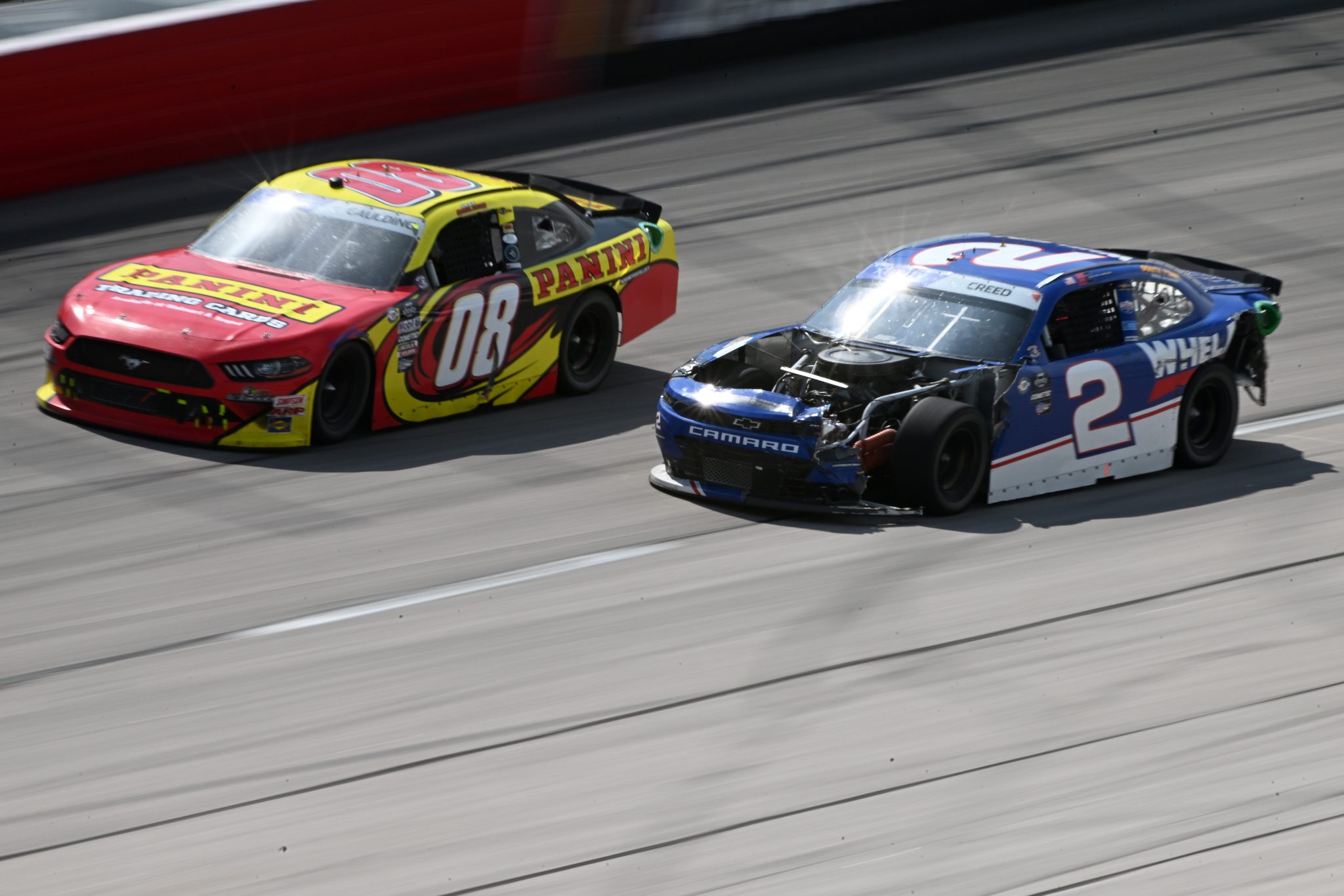 DARLINGTON, SOUTH CAROLINA - MAY 13: Sheldon Creed, driver of the #2 Whelen Chevrolet, races a damaged car against Gray Gaulding, driver of the #08 Panini Ford, during the NASCAR Xfinity Series Shriners Children's 200 at Darlington Raceway on May 13, 2023 in Darlington, South Carolina. (Photo by Logan Riely/Getty Images) | Getty Images