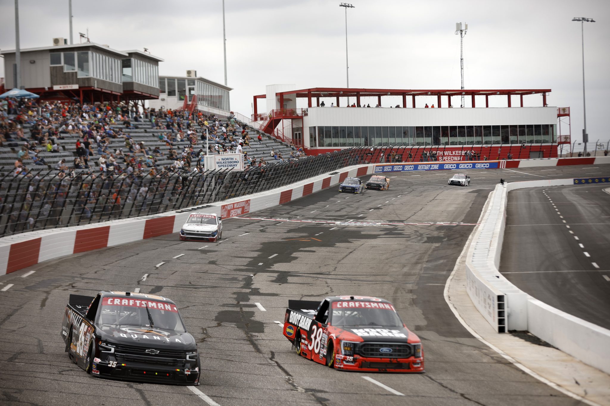 NORTH WILKESBORO, NORTH CAROLINA - MAY 19: Jake Garcia, driver of the #35 Quanta Chevrolet, and Zane Smith, driver of the #38 Boot Barn Ford, drive during practice for the NASCAR Craftsman Truck Series Tyson 250 at North Wilkesboro Speedway on May 19, 2023 in North Wilkesboro, North Carolina. (Photo by Sean Gardner/Getty Images) | Getty Images