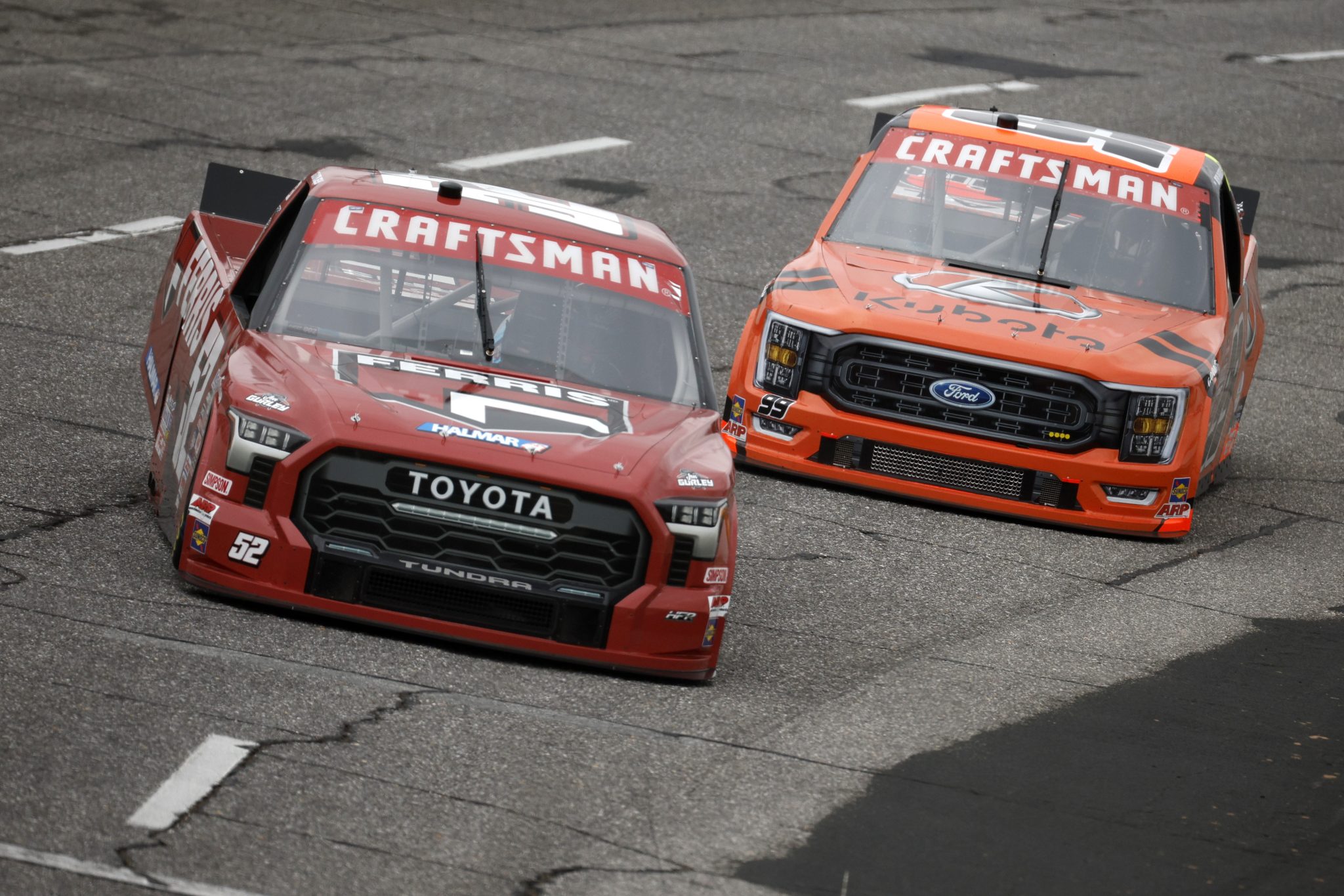 NORTH WILKESBORO, NORTH CAROLINA - MAY 19: Stewart Friesen, driver of the #52 Ferris Commercial Mowers Toyota, and Ben Rhodes, driver of the #99 Kubota Ford, drive during practice for the NASCAR Craftsman Truck Series Tyson 250 at North Wilkesboro Speedway on May 19, 2023 in North Wilkesboro, North Carolina. (Photo by Sean Gardner/Getty Images) | Getty Images