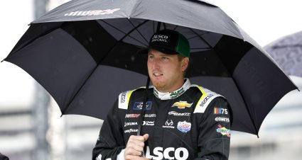CONCORD, NORTH CAROLINA - MAY 27: Austin Hill, driver of the #21 Alsco Chevrolet, walks the grid under an umbrella prior to the NASCAR Xfinity Series Alsco Uniforms 300 at Charlotte Motor Speedway on May 27, 2023 in Concord, North Carolina. (Photo by Jared C. Tilton/Getty Images) | Getty Images