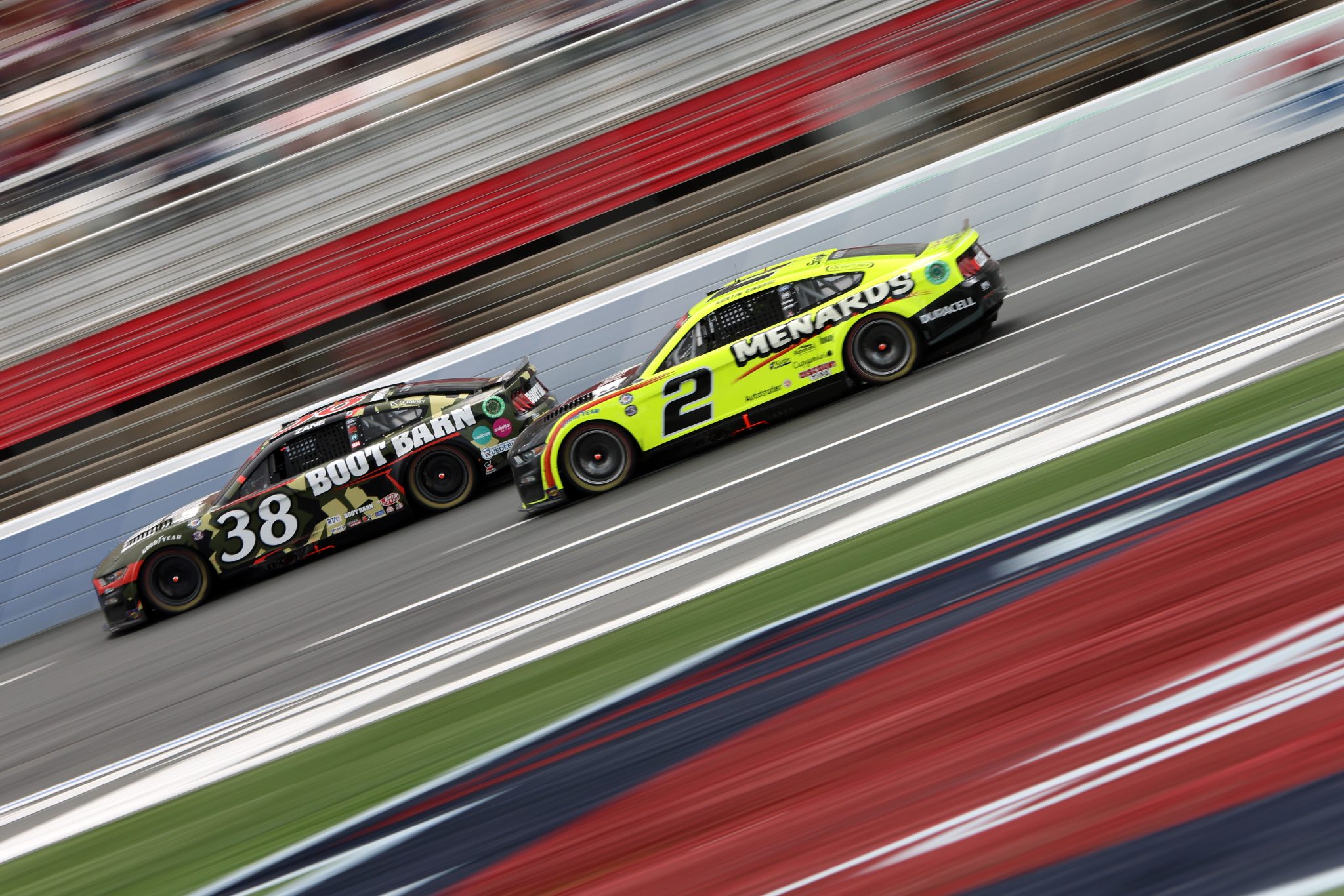 CONCORD, NORTH CAROLINA - MAY 29: Zane Smith, driver of the #38 Boot Barn Ford, and Austin Cindric, driver of the #2 Menards/Duracell Ford, race during the NASCAR Cup Series Coca-Cola 600 at Charlotte Motor Speedway on May 29, 2023 in Concord, North Carolina. (Photo by David Jensen/Getty Images) | Getty Images