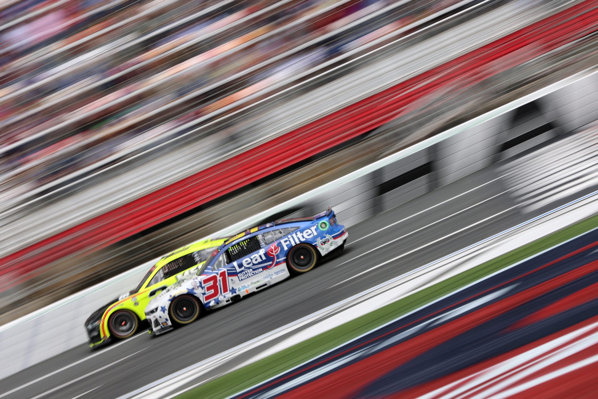 CONCORD, NORTH CAROLINA - MAY 29: Justin Haley, driver of the #31 LeafFilter Gutter Protection Chevrolet, and Austin Cindric, driver of the #2 Menards/Duracell Ford, race during the NASCAR Cup Series Coca-Cola 600 at Charlotte Motor Speedway on May 29, 2023 in Concord, North Carolina. (Photo by David Jensen/Getty Images) | Getty Images