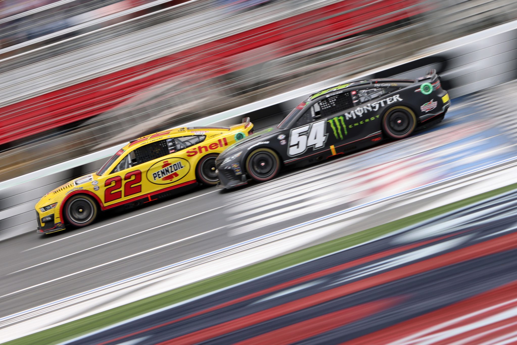 CONCORD, NORTH CAROLINA - MAY 29: Joey Logano, driver of the #22 Shell Pennzoil Ford, and Ty Gibbs, driver of the #54 Monster Energy Toyota, race during the NASCAR Cup Series Coca-Cola 600 at Charlotte Motor Speedway on May 29, 2023 in Concord, North Carolina. (Photo by David Jensen/Getty Images) | Getty Images