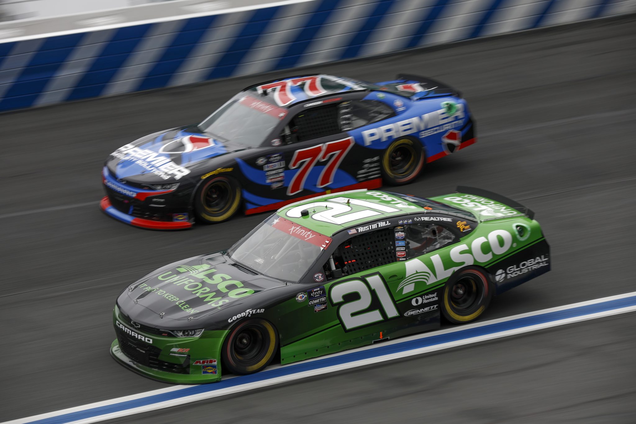 CONCORD, NORTH CAROLINA - MAY 29: Austin Hill, driver of the #21 Alsco Chevrolet, and Carson Hocevar, driver of the #77 Premier Security Chevrolet, race during the NASCAR Xfinity Series Alsco Uniforms 300 at Charlotte Motor Speedway on May 29, 2023 in Concord, North Carolina. (Photo by Jared C. Tilton/Getty Images) | Getty Images