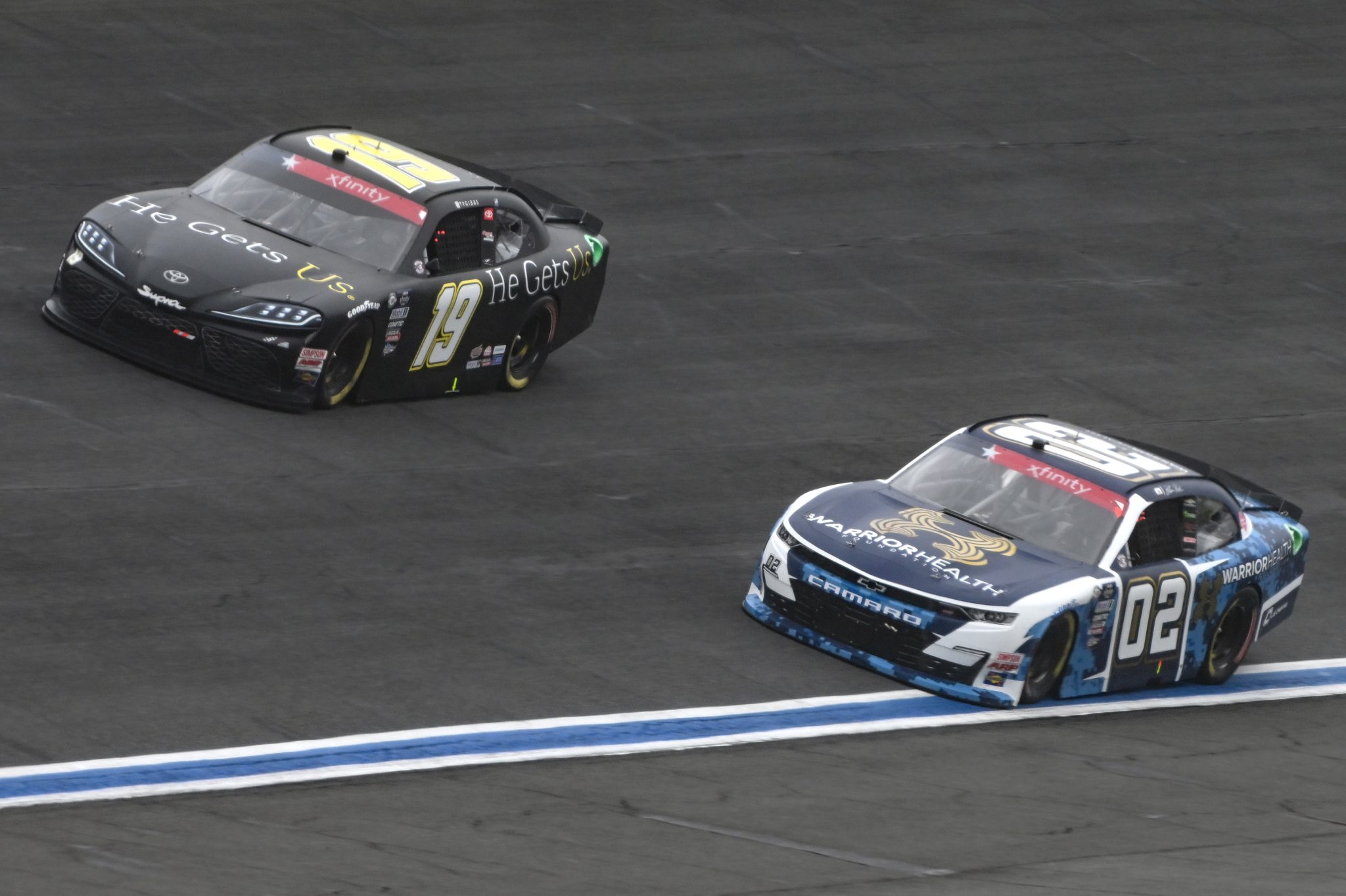 CONCORD, NORTH CAROLINA - MAY 29: Ty Gibbs, driver of the #19 He Gets Us Toyota, and Blaine Perkins, driver of the #02 Our Motorsports Chevrolet, race during the NASCAR Xfinity Series Alsco Uniforms 300 at Charlotte Motor Speedway on May 29, 2023 in Concord, North Carolina. (Photo by Logan Riely/Getty Images) | Getty Images