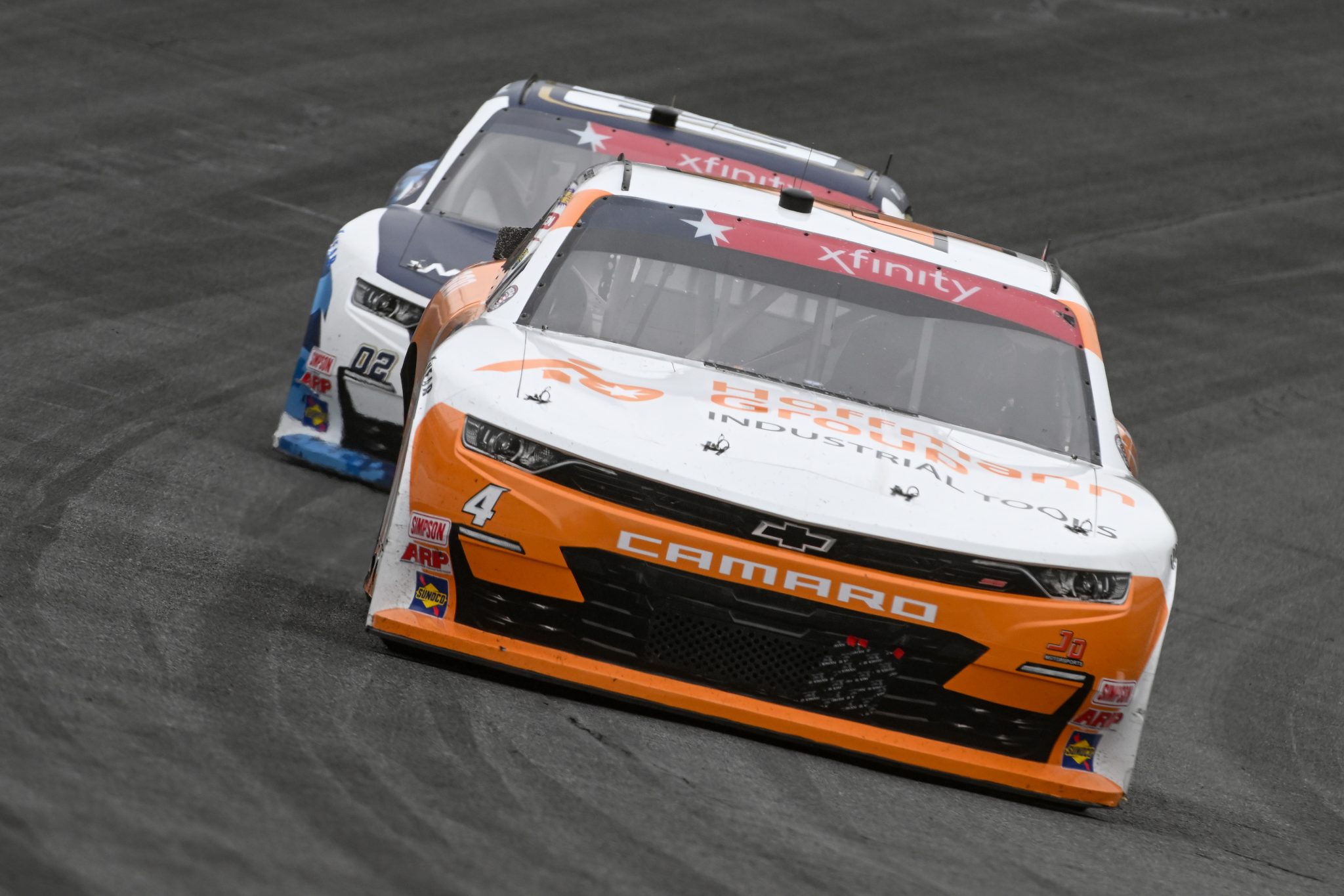 CONCORD, NORTH CAROLINA - MAY 29: Garrett Smithley, driver of the #4 Hoffman Tool Chevrolet, and Blaine Perkins, driver of the #02 Our Motorsports Chevrolet, race during the NASCAR Xfinity Series Alsco Uniforms 300 at Charlotte Motor Speedway on May 29, 2023 in Concord, North Carolina. (Photo by Logan Riely/Getty Images) | Getty Images