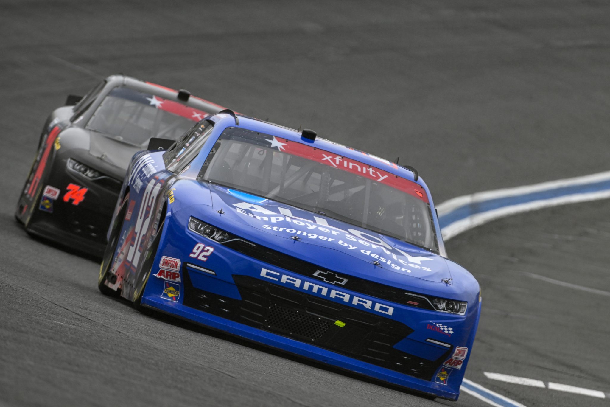 CONCORD, NORTH CAROLINA - MAY 29: Josh Williams, driver of the #92 Alloy Employer Services Chevrolet, and Dawson Cram, driver of the #74 CHK Racing Chevrolet, race during the NASCAR Xfinity Series Alsco Uniforms 300 at Charlotte Motor Speedway on May 29, 2023 in Concord, North Carolina. (Photo by Logan Riely/Getty Images) | Getty Images