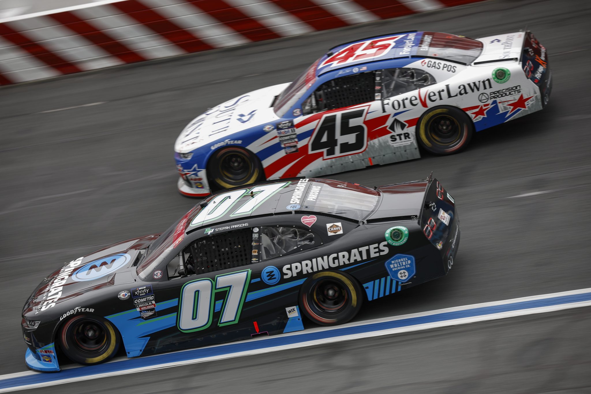 CONCORD, NORTH CAROLINA - MAY 29: Stefan Parsons, driver of the #07 SPRINGRATES Chevrolet, and Jeffrey Earnhardt, driver of the #45 SouthPoint Bank/ForeverLawn Chevrolet, race during the NASCAR Xfinity Series Alsco Uniforms 300 at Charlotte Motor Speedway on May 29, 2023 in Concord, North Carolina. (Photo by Jared C. Tilton/Getty Images) | Getty Images
