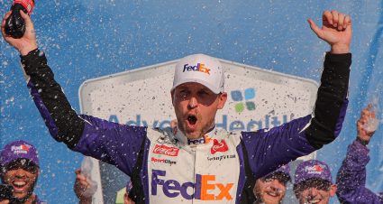 KANSAS CITY, KANSAS - MAY 07: Denny Hamlin, driver of the #11 FedEx Express Toyota, celebrates in victory lane after winning the NASCAR Cup Series Advent Health 400 at Kansas Speedway on May 07, 2023 in Kansas City, Kansas. (Photo by Jonathan Bachman/Getty Images) | Getty Images