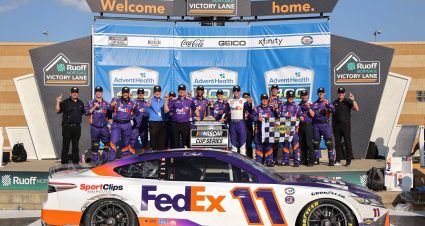 KANSAS CITY, KANSAS - MAY 07: Denny Hamlin, driver of the #11 FedEx Express Toyota, and crew celebrate in victory lane after winning the NASCAR Cup Series Advent Health 400 at Kansas Speedway on May 07, 2023 in Kansas City, Kansas. (Photo by Jonathan Bachman/Getty Images) | Getty Images