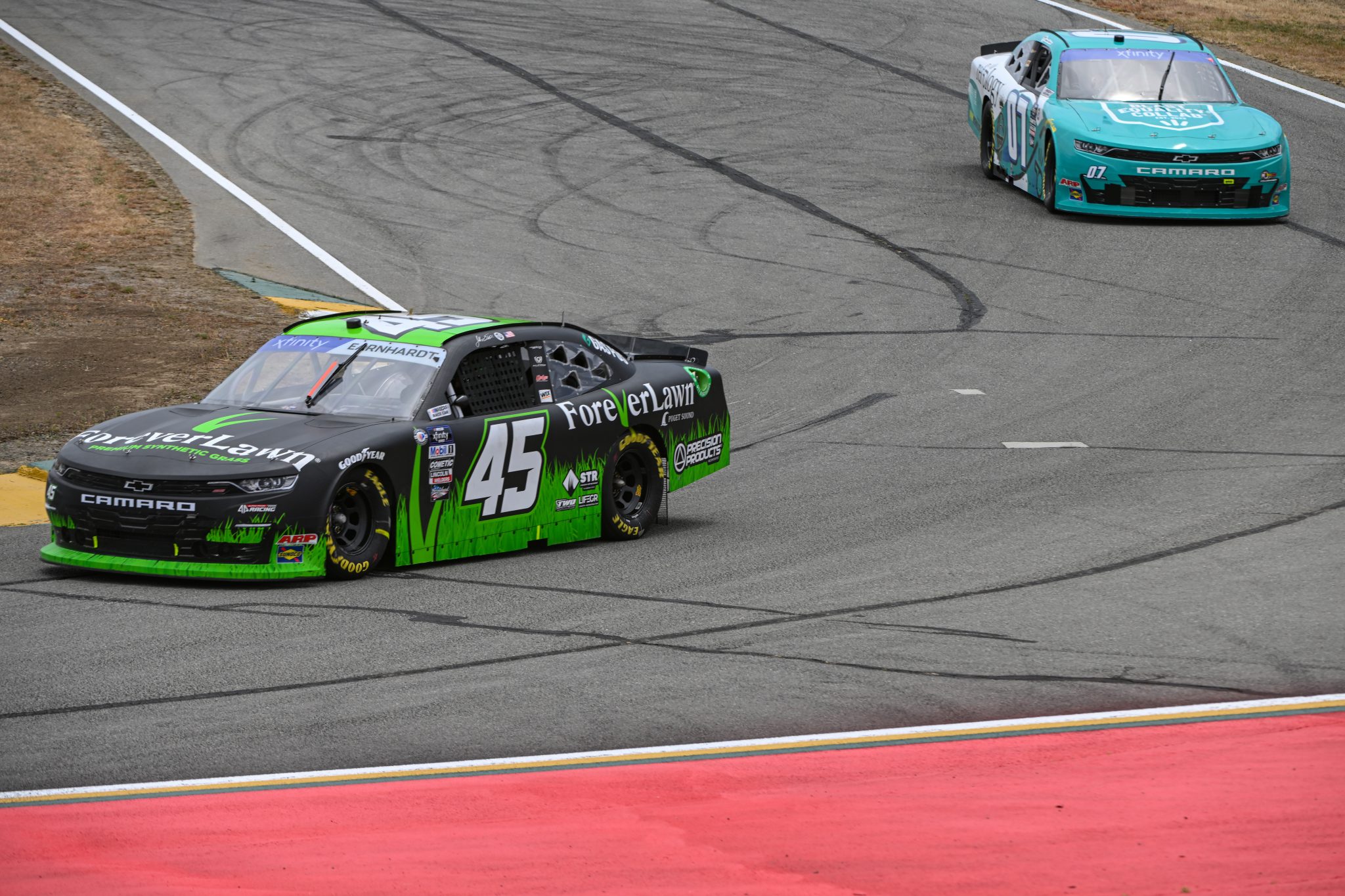SONOMA, CALIFORNIA - JUNE 09: Jeffrey Earnhardt, driver of the #45 ForeverLawn Chevrolet, and Daniel Suarez, driver of the #07 Refology/Blast Equality Collab Chevrolet, drive during practice for the NASCAR Xfinity Series DoorDash 250 at Sonoma Raceway on June 09, 2023 in Sonoma, California. (Photo by Logan Riely/Getty Images) | Getty Images