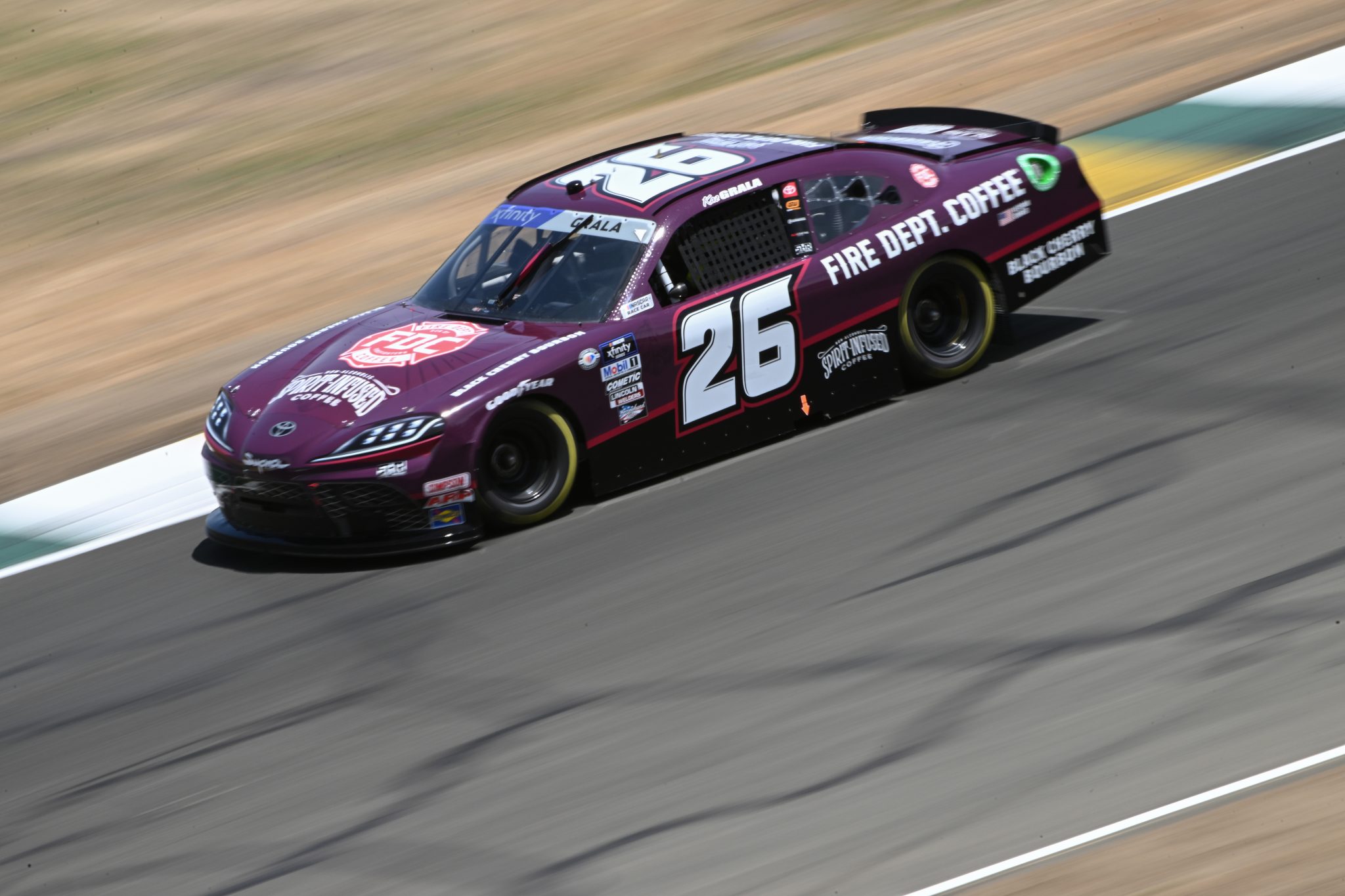 SONOMA, CALIFORNIA - JUNE 10: Kaz Grala, driver of the #26 FDC Black Cherry Bourbon Toyota, drives during qualifying for the NASCAR Xfinity Series DoorDash 250 at Sonoma Raceway on June 10, 2023 in Sonoma, California. (Photo by Logan Riely/Getty Images) | Getty Images