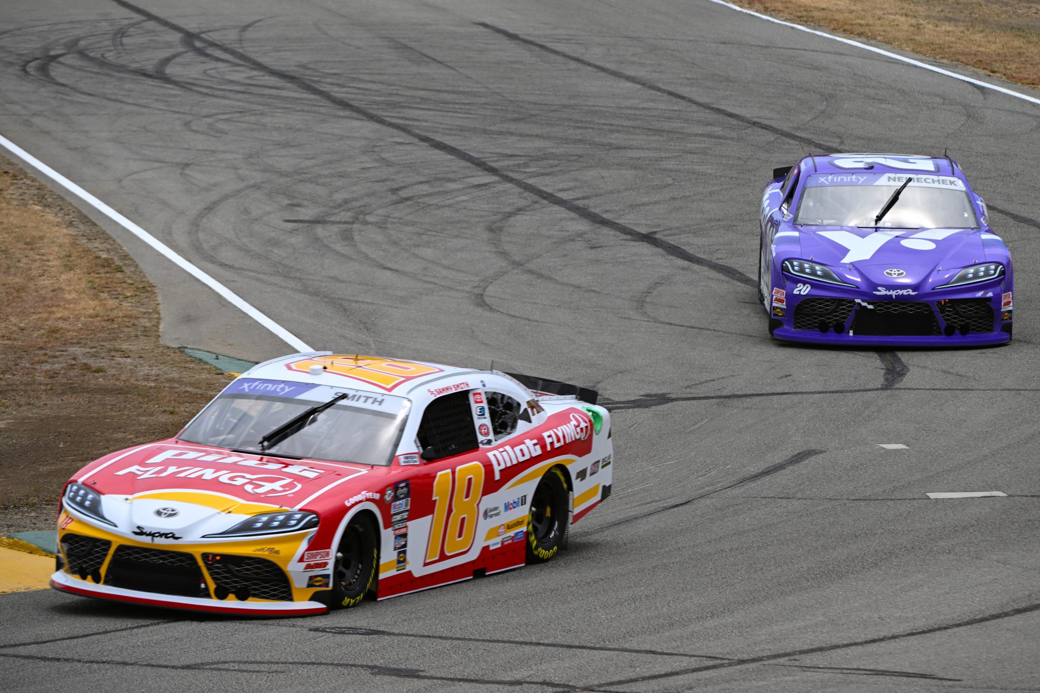 SONOMA, CALIFORNIA - JUNE 09: Sammy Smith, driver of the #18 Pilot Flying J Toyota, and John Hunter Nemechek, driver of the #20 Yahoo Toyota, drive during practice for the NASCAR Xfinity Series DoorDash 250 at Sonoma Raceway on June 09, 2023 in Sonoma, California. (Photo by Logan Riely/Getty Images) | Getty Images