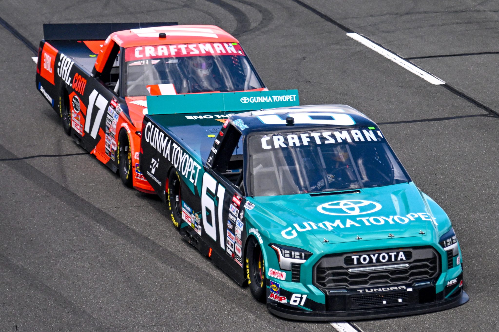 LONG POND, PENNSYLVANIA - JULY 22: Christopher Bell, driver of the #61 Gunma Toyopet Toyota, and Taylor Gray, driver of the #17 JBL Toyota, race during the NASCAR Craftsman Truck Series CRC Brakleen 150 at Pocono Raceway on July 22, 2023 in Long Pond, Pennsylvania. (Photo by Logan Riely/Getty Images) | Getty Images