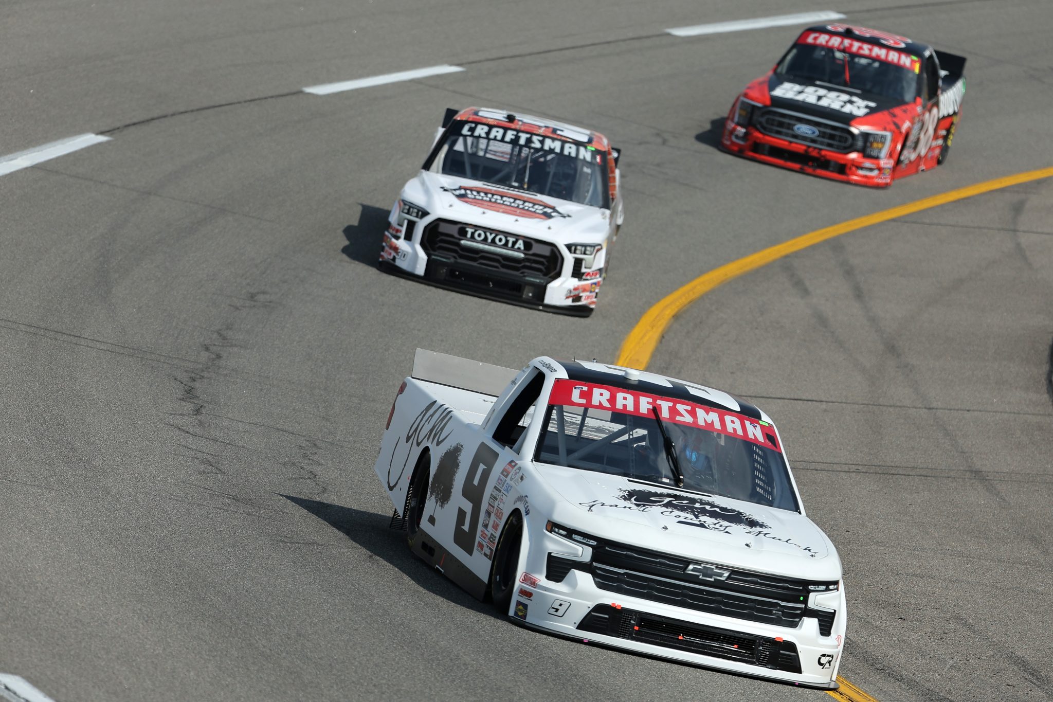 RICHMOND, VIRGINIA - JULY 28: Colby Howard, driver of the #9 Grant County Mulch Chevrolet, Ryan Vargas, driver of the #30 Williamsburg Contracting Toyota, and Zane Smith, driver of the #38 Boot Barn Ford, drive during practice for the NASCAR Craftsman Truck Series Worldwide Express 250 at Richmond Raceway on July 28, 2023 in Richmond, Virginia. (Photo by Jonathan Bachman/Getty Images) | Getty Images