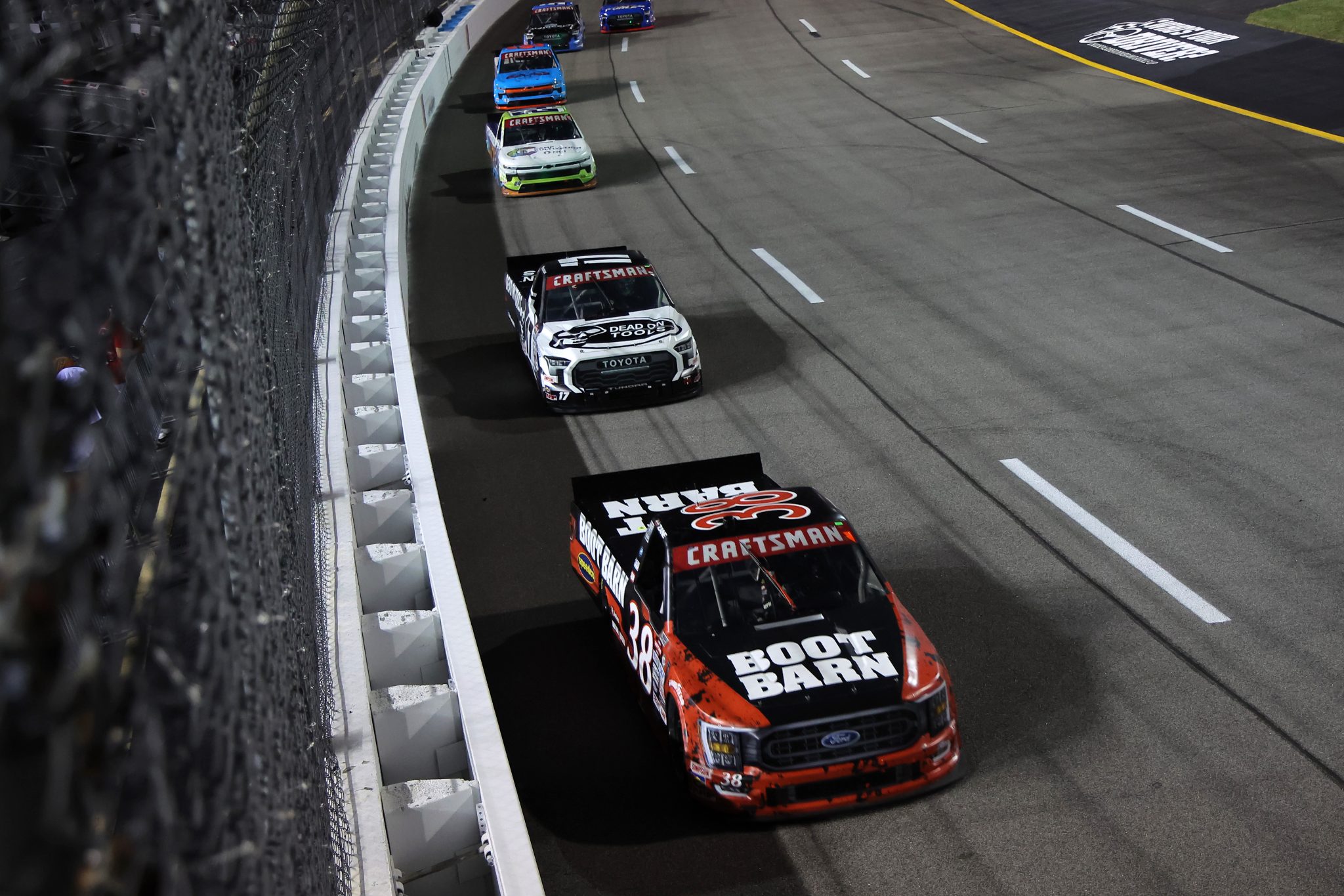 RICHMOND, VIRGINIA - JULY 29: Zane Smith, driver of the #38 Boot Barn Ford, Taylor Gray, driver of the #17 Dead On Tools Toyota, and Rajah Caruth, driver of the #24 Camp Cultivation Chevrolet, race during the NASCAR Craftsman Truck Series Worldwide Express 250 at Richmond Raceway on July 29, 2023 in Richmond, Virginia. (Photo by Jonathan Bachman/Getty Images) | Getty Images