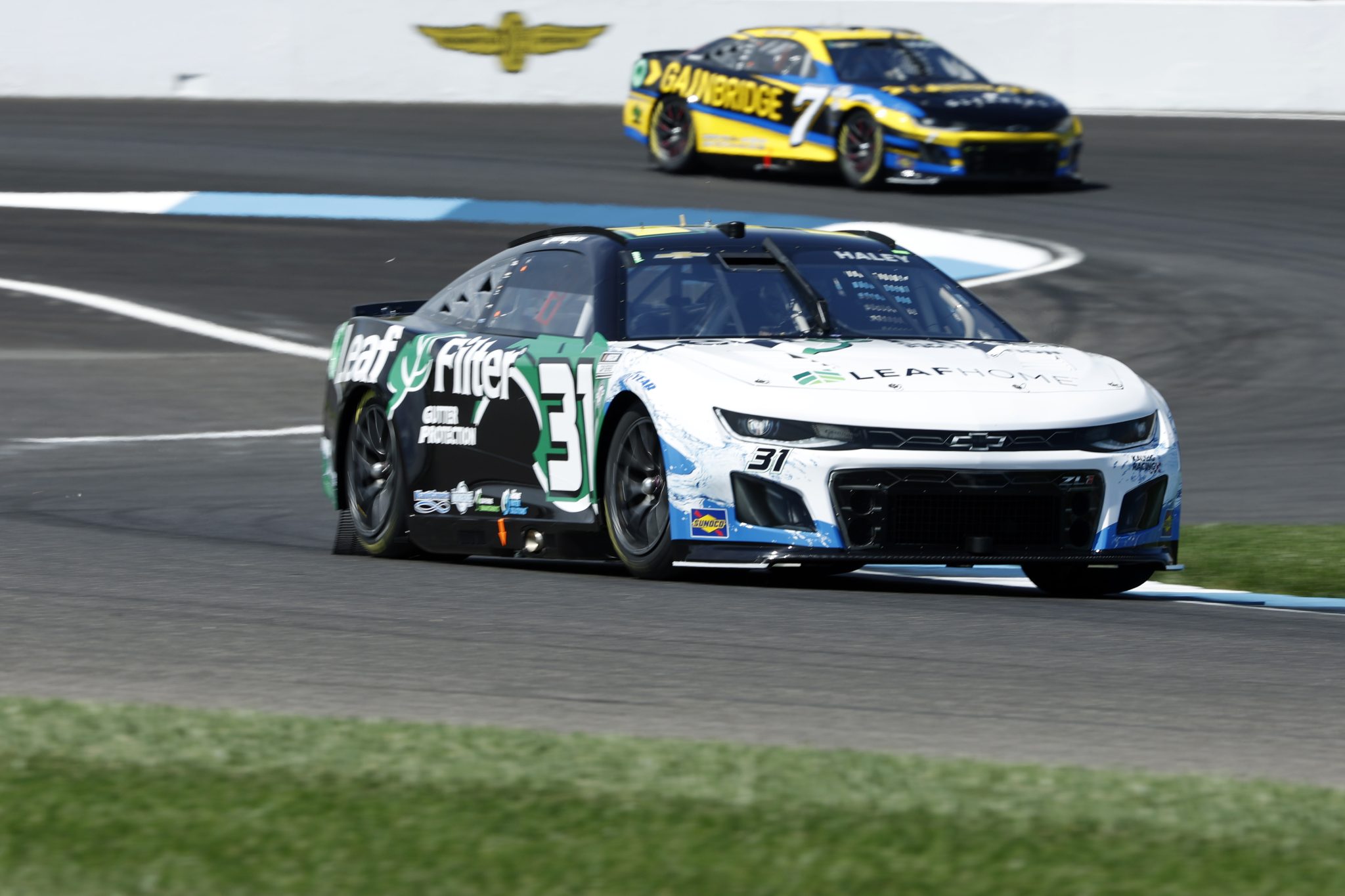 INDIANAPOLIS, INDIANA - AUGUST 12: Justin Haley, driver of the #31 LeafFilter Gutter Protection Chevrolet, and Corey LaJoie, driver of the #7 Gainbridge Chevrolet, drive during practice for the NASCAR Cup Series Verizon 200 at the Brickyard at Indianapolis Motor Speedway on August 12, 2023 in Indianapolis, Indiana. (Photo by Justin Casterline/Getty Images) | Getty Images