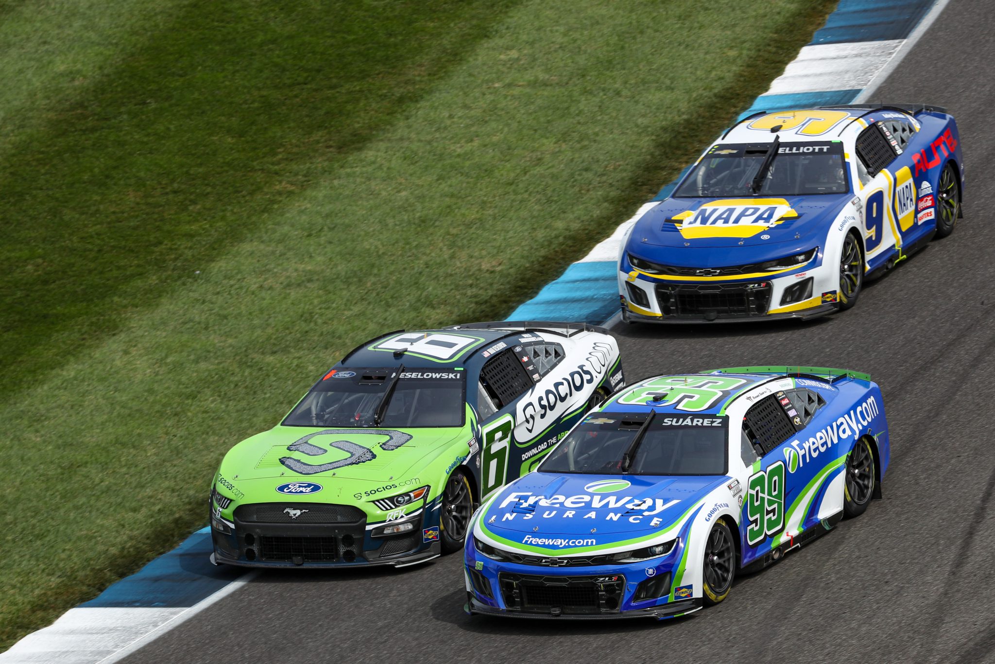 INDIANAPOLIS, INDIANA - AUGUST 13: Brad Keselowski, driver of the #6 Socios.com Ford, Daniel Suarez, driver of the #99 Freeway.com Chevrolet, and Chase Elliott, driver of the #9 NAPA Auto Parts Chevrolet, race during the NASCAR Cup Series Verizon 200 at the Brickyard at Indianapolis Motor Speedway on August 13, 2023 in Indianapolis, Indiana. (Photo by Meg Oliphant/Getty Images) | Getty Images