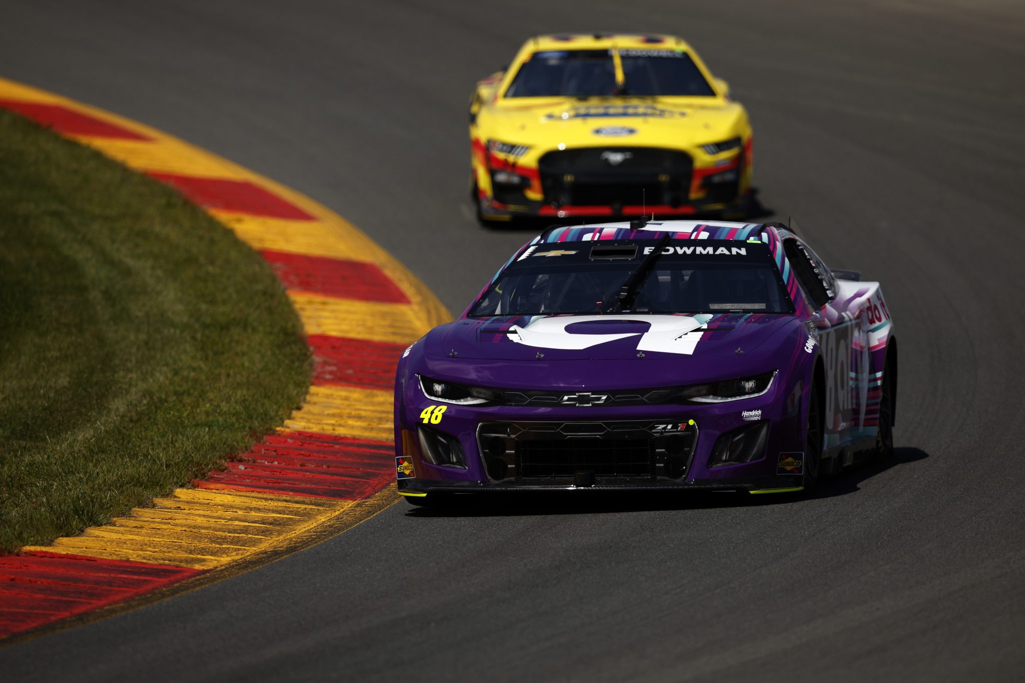 WATKINS GLEN, NEW YORK - AUGUST 19: Alex Bowman, driver of the #48 Ally Chevrolet, and Michael McDowell, driver of the #34 Love's Travel Stops Ford, drive during practice for the NASCAR Cup Series Go Bowling at The Glen at Watkins Glen International on August 19, 2023 in Watkins Glen, New York. (Photo by Sean Gardner/Getty Images) | Getty Images